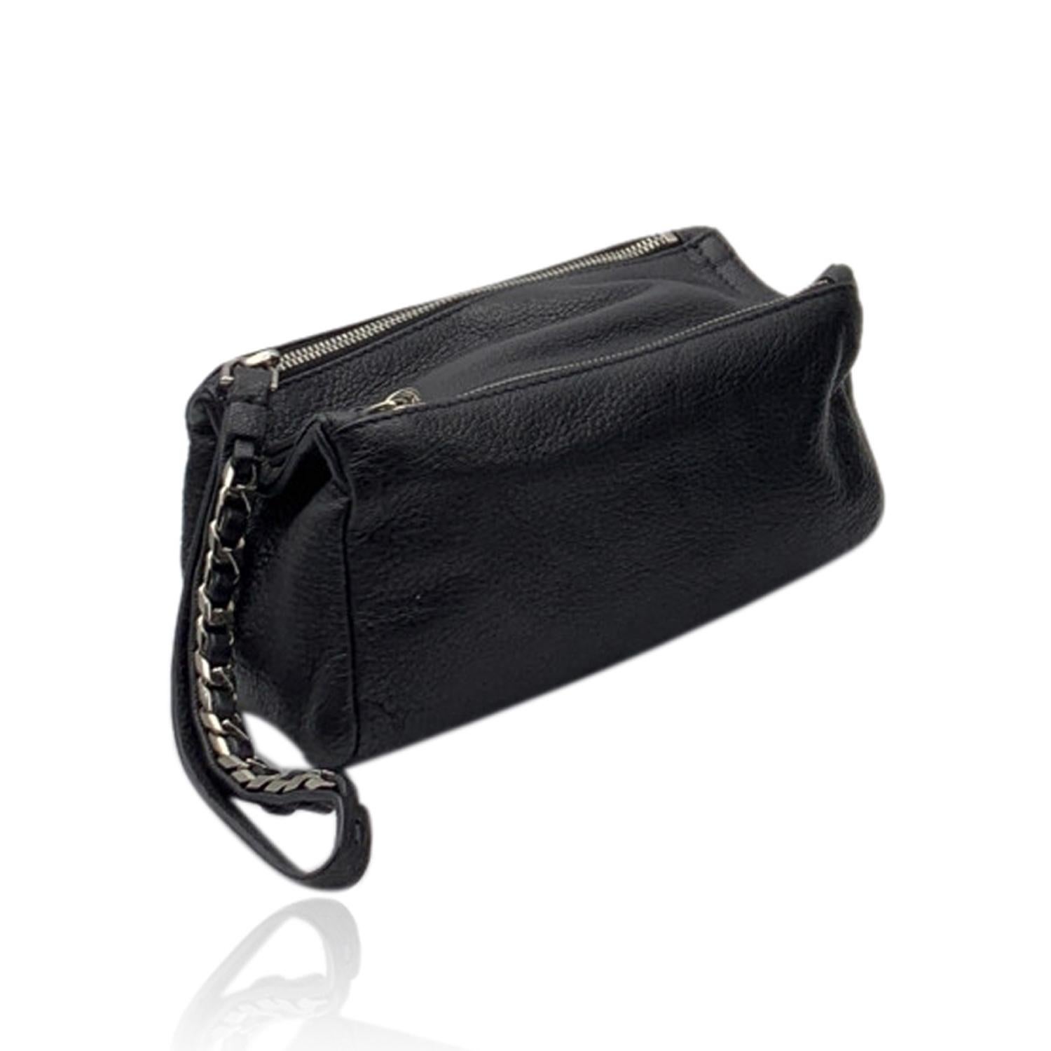 Givenchy 'Pandora' pouch clutch bag. Black leather and silver metal hardware. Chain and leather wrist strap. 2 compartments with upper zipper closure. Silver metal logo lettering on top. Black canvas lining. 'Givenchy - Made in Italy' tag