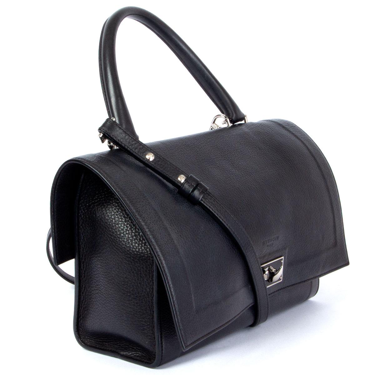100% authentic Givenchy Shark Mini shoulder bag in black grained leather. Opens with a flap and turn-lock and is lined in black suede with one zipper  and open pocket against the back. Comes with an adjustable and detachable shoulder strap. Has been