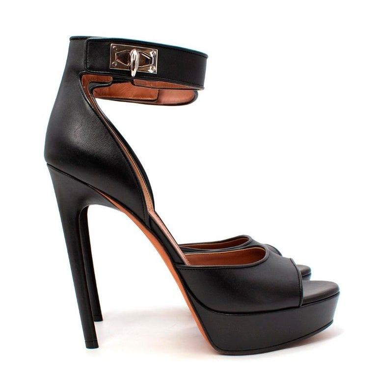 Givenchy Black Leather Shark Tooth Ankle Strap Heeled Sandals
 

 - Black smooth leather sandals with open toe and silver-tone shark tooth ankle strap
 - Set on a small front platform and high stiletto heel
 

 Materials:
 Leather
 

 Made in Italy
