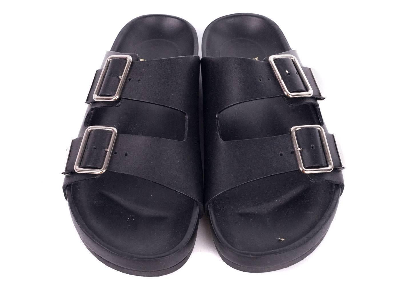 Strut in style with cool-chic elegance courtesy of Givenchy. This sandal is the ultimate minimalistic, long wearing slide. Featuring a simplistic design and dual buckle strap with silver accents. Slide into these for a busy day of errands or
