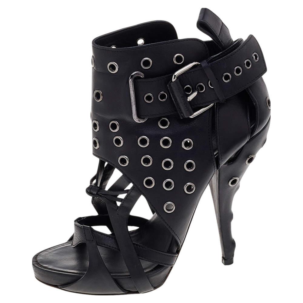 Let your luxe styling choices be evident as you wear these beauties from the House of Givenchy. These boots are made from black leather and accented with studded details on the strappy upper. Silver-toned hardware is used to embellish them. Take