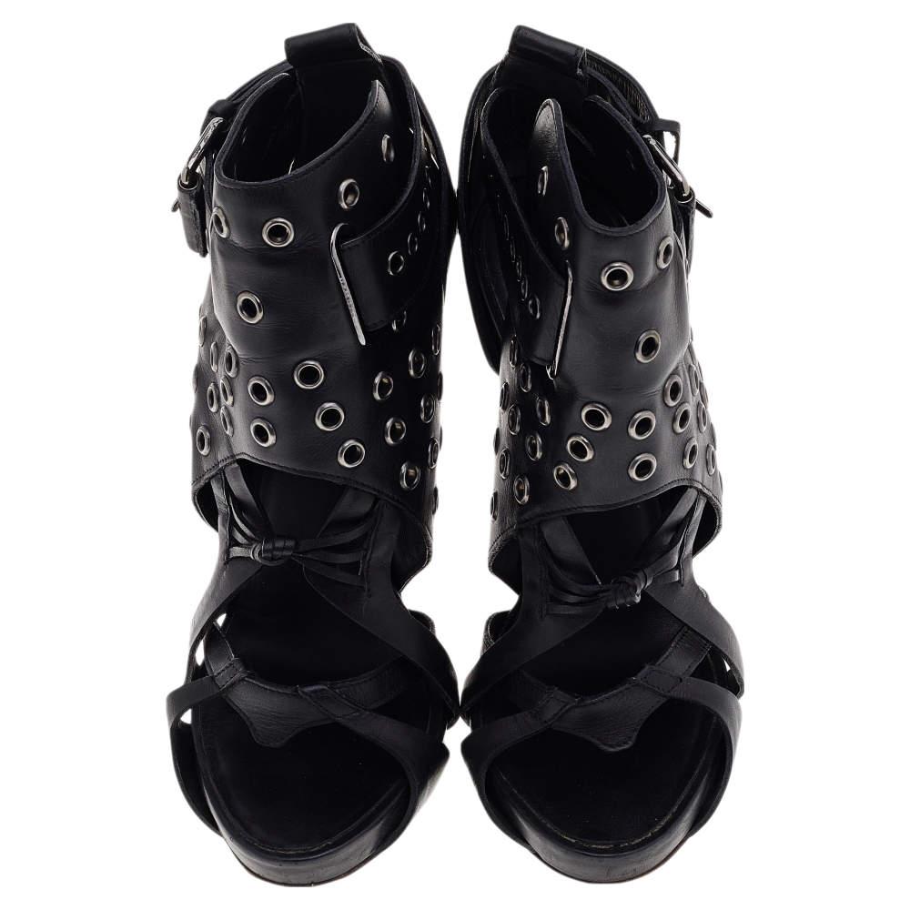 Let your luxe styling choices be evident as you wear these beauties from the House of Givenchy. These boots are made from black leather and accented with studded details on the strappy upper. Silver-toned hardware is used to embellish them. Take