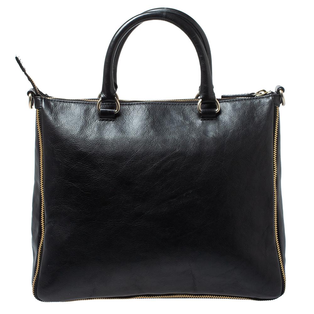 If you're looking for a bag with a blend of modern style and functionality, this Givenchy tote is the answer. Crafted from quality leather, this black bag features zip details, two handles, a shoulder strap and a spacious fabric-lined interior. This