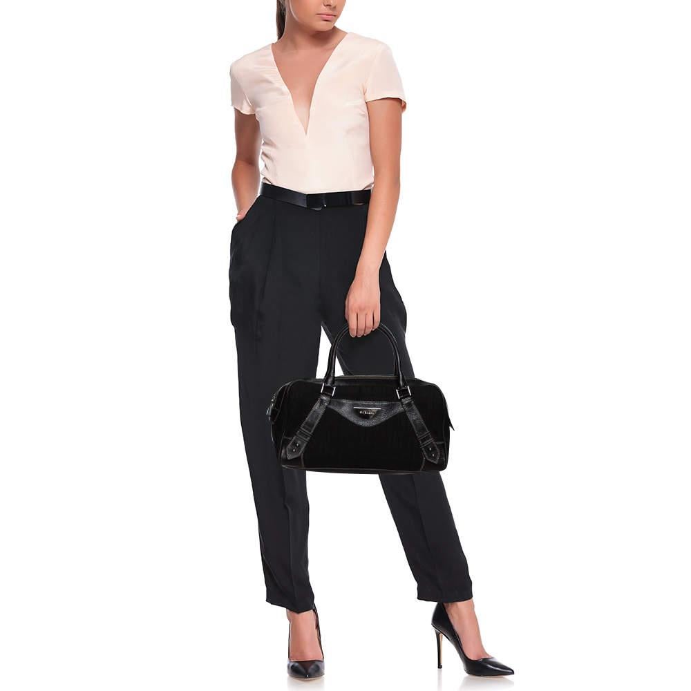 Stunning in appeal and high on style, this Givenchy satchel has been crafted from monogram canvas and leather and designed minimally with silver-tone hardware and contrasting stitch details. It comes with dual top handles and the brand logo plaque