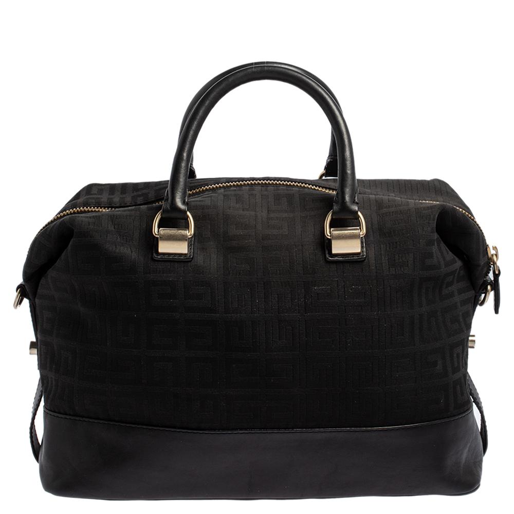 This Givenchy satchel arrives in a gorgeous shape and design. It has a monogram canvas and leather body with logo detailing on the front and is held by two handles. The top zipper secures the spacious fabric interior and overall, the black satchel
