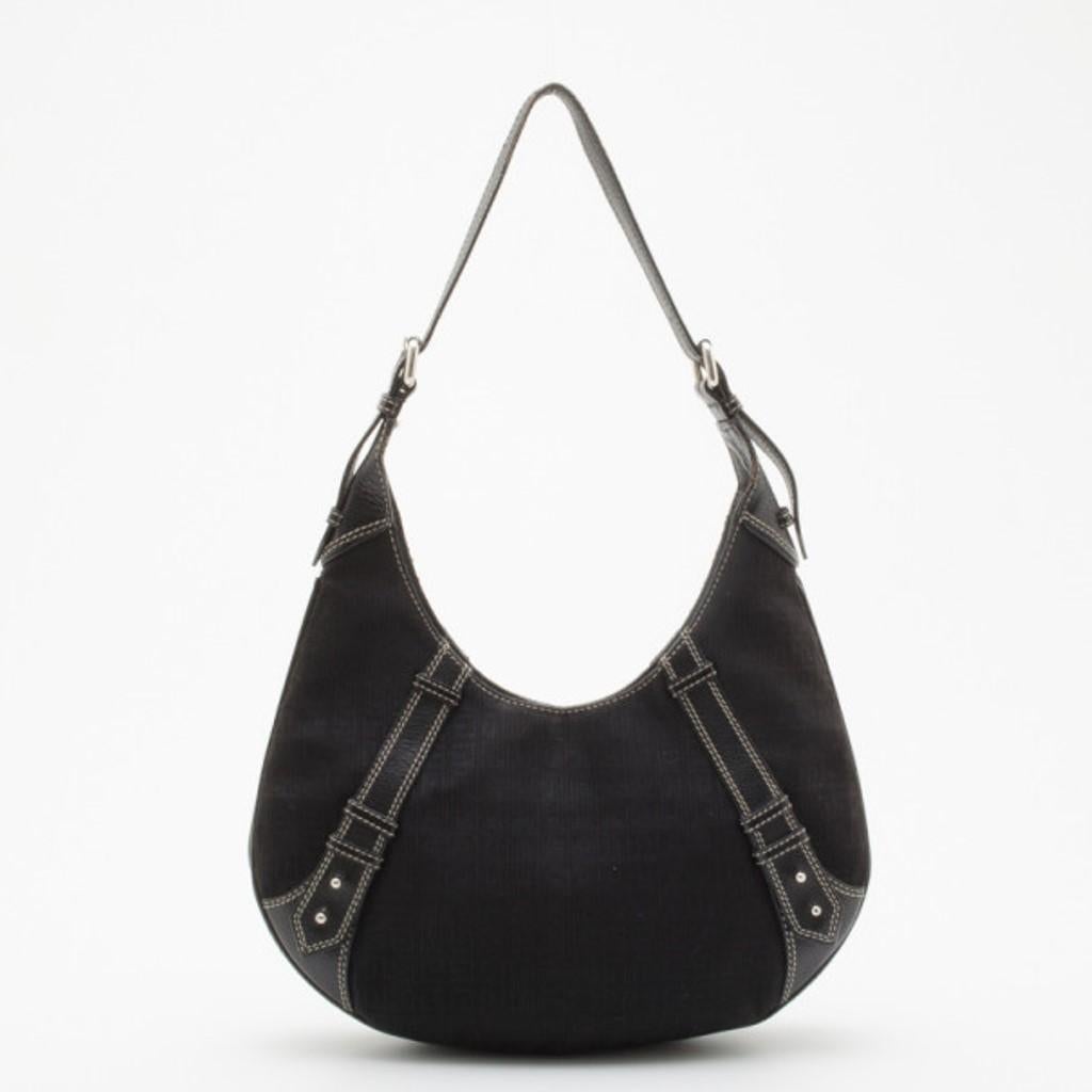 Carry this stylish and contemporary Givenchy Black Monogram leather Hobo everywhere. It is crafted from monogram canvas and black leather trim with tack stitching. This bag features a silver metal Givenchy plate and an adjustable leather strap. The