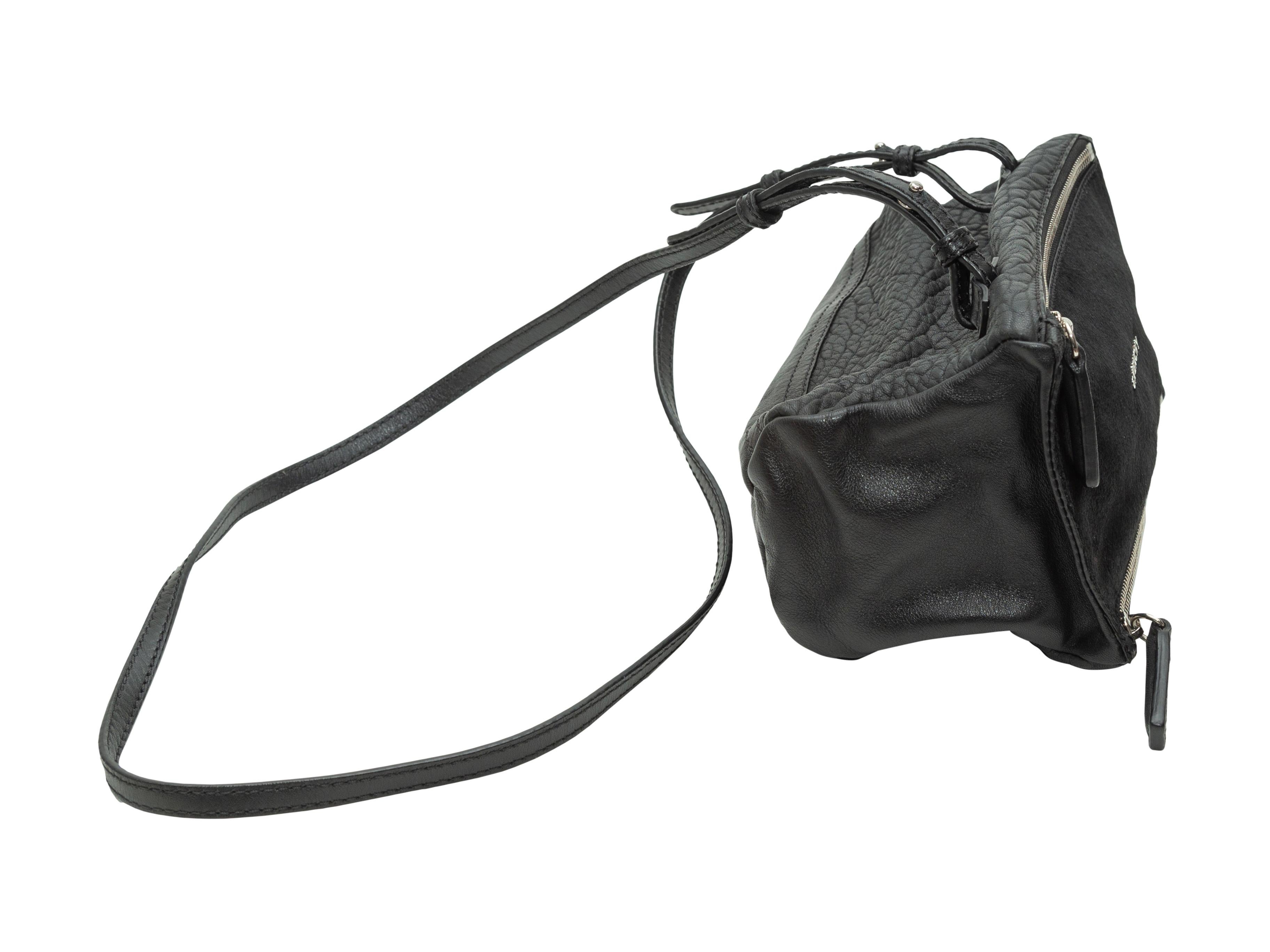 Product Details: Black ponyhair and leather 'Pandora' crossbody bag by Givenchy. Silver-tone hardware. Interior zip pocket. Adjustable shoulder strap. Dual exterior zip closures. 9.5