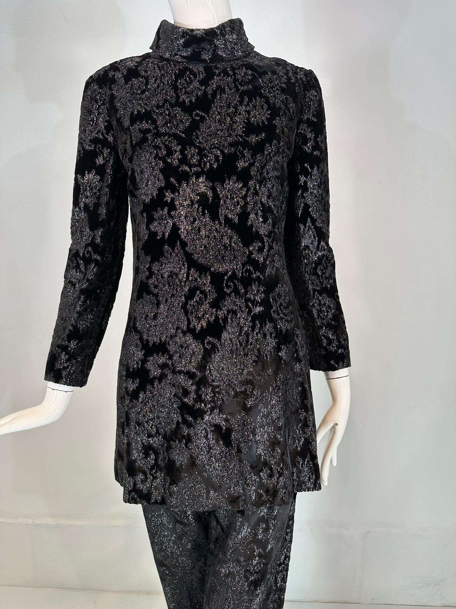 Givenchy black princess seam glittery paisley velvet tunic & pant set from the 1970s. Glittery black velvet set features a princess seam, A line shape tunic with a turtle neck, long sleeves. There are side front hem vents, the top is fully lined and