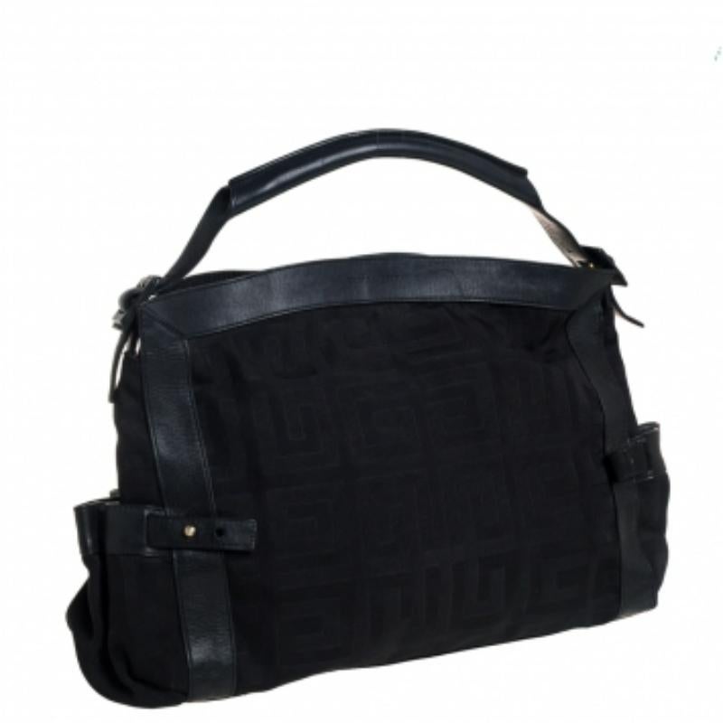 This black satchel from Givenchy will give you days of style and ease. It is crafted from the signature canvas and leather and features gold-tone hardware. It is equipped with a spacious fabric interior and a single top handle and it flaunts an