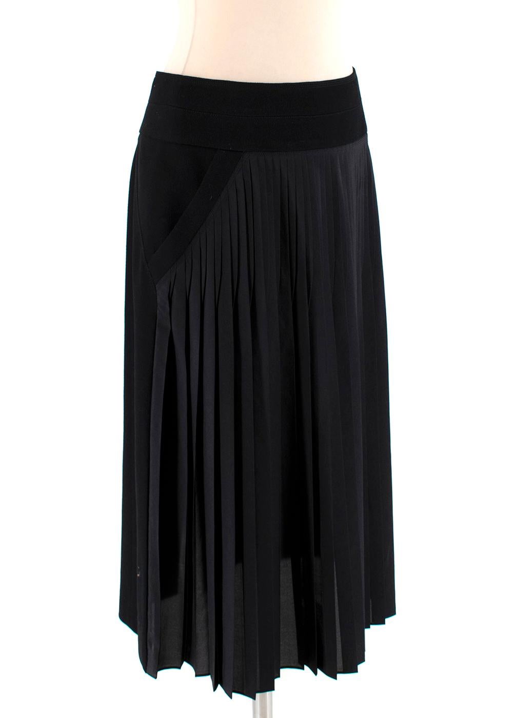 Givenchy Black Silk Blend Pleated Midi Skirt

-Made of a soft lightweight silk blend fabric to the front, wool to the back 
-Luxurious full silk lining 
-Beautiful pleated texture 
-2 pockets to the front 
-Slit to the back 
-Zip fastening to the