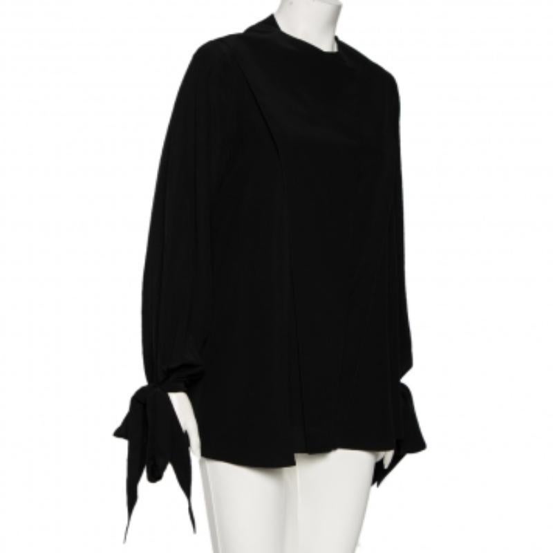 This shirt from Givenchy is all you need to display a polished style for the day. Stitched using black silk with a gorgeous tie detailing, this collarless shirt truly makes an essential addition to your closet. This piece is equipped with a
