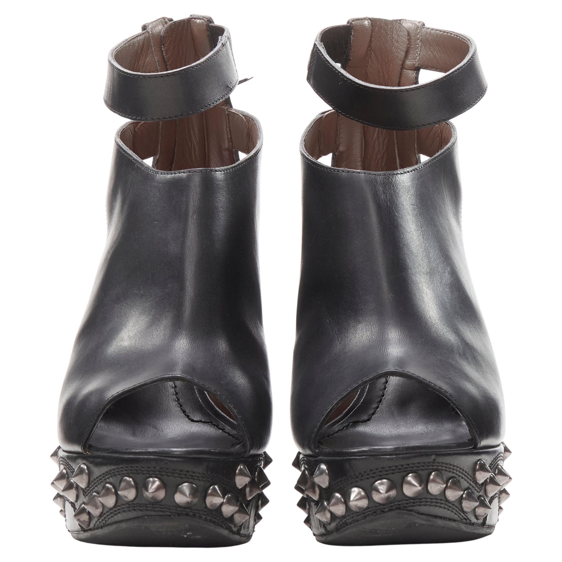 GIVENCHY black silver spike baroque studded platform wedge gladiator EU36.5
Brand: Givenchy
Designer: Riccardo Tisci
Material: Leather
Color: Black
Pattern: Solid
Closure: Zip
Extra Detail: Ankle strap with zip back closure.

CONDITION:
Condition: