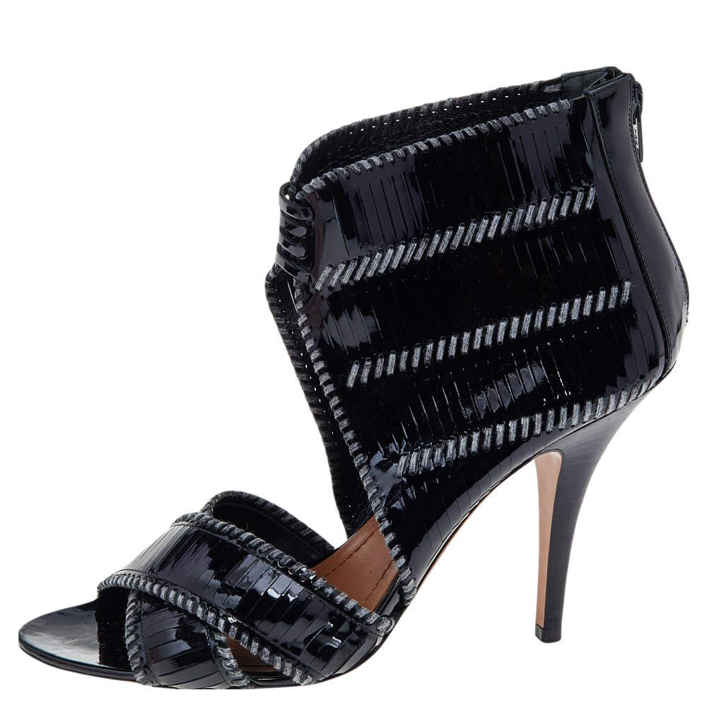 With this design, Givenchy makes sure one knows the label at first glance. An open-toe black patent leather bootie is lifted on a leather outsole and slim heel, secured with a zipper on the back.


