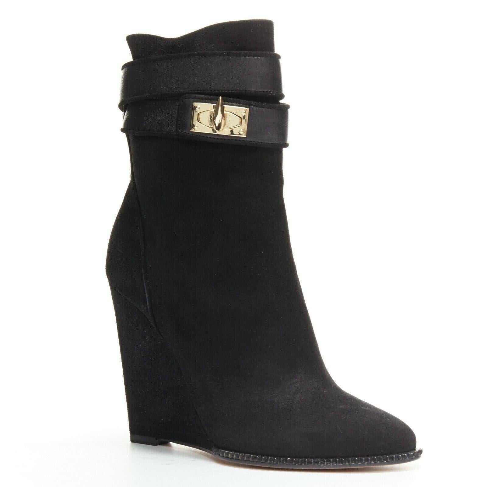GIVENCHY black suede gold shark tooth lock clasp closure wedge booties EU36.5
GIVENCHY BY RICCARDO TISCI
Shark tooth lock. 
Black suede upper. 
Wedged heel. 
Ankle booties. 
Gold-tone shark tooth twist lock closure. 
Pointed toe. 
Ridged detailing