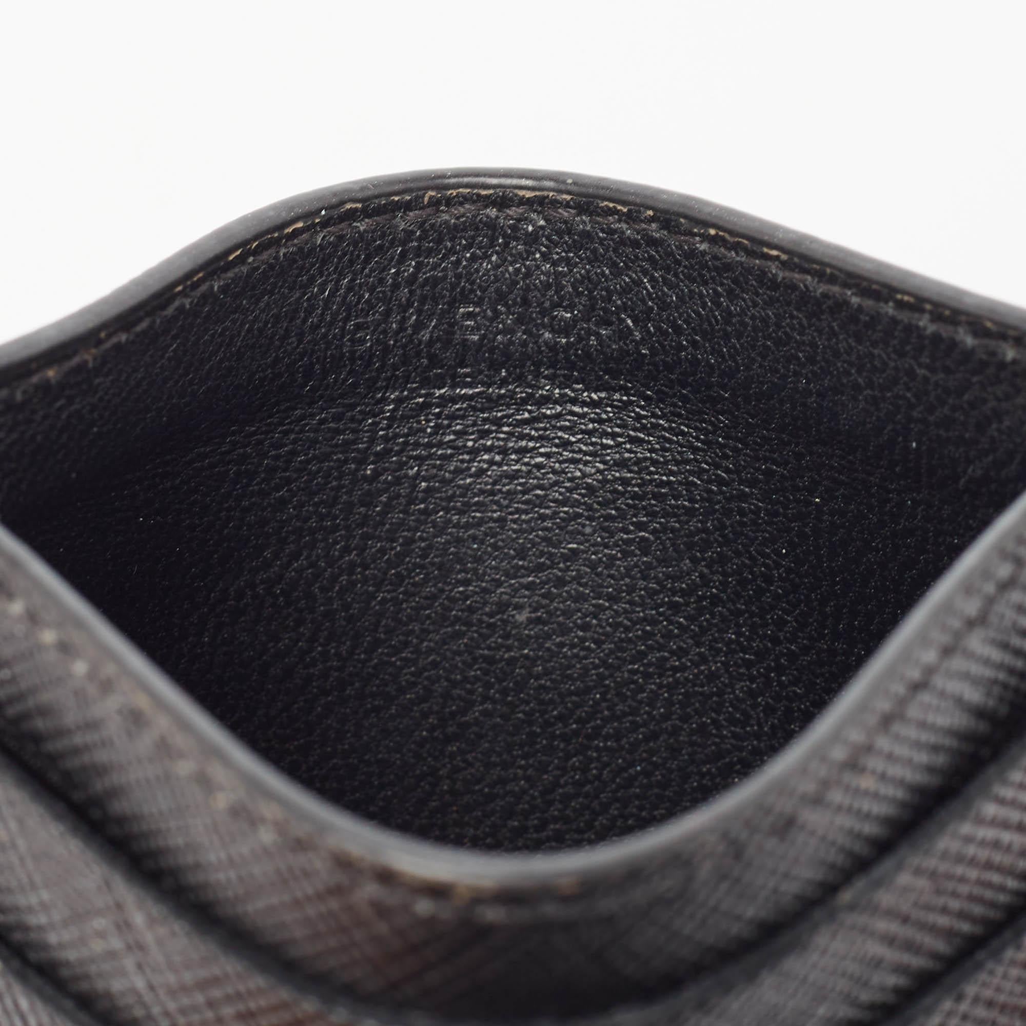 The card holder combines elegance and functionality in a sleek design. Crafted from black leather it has the brand name in white on the front.