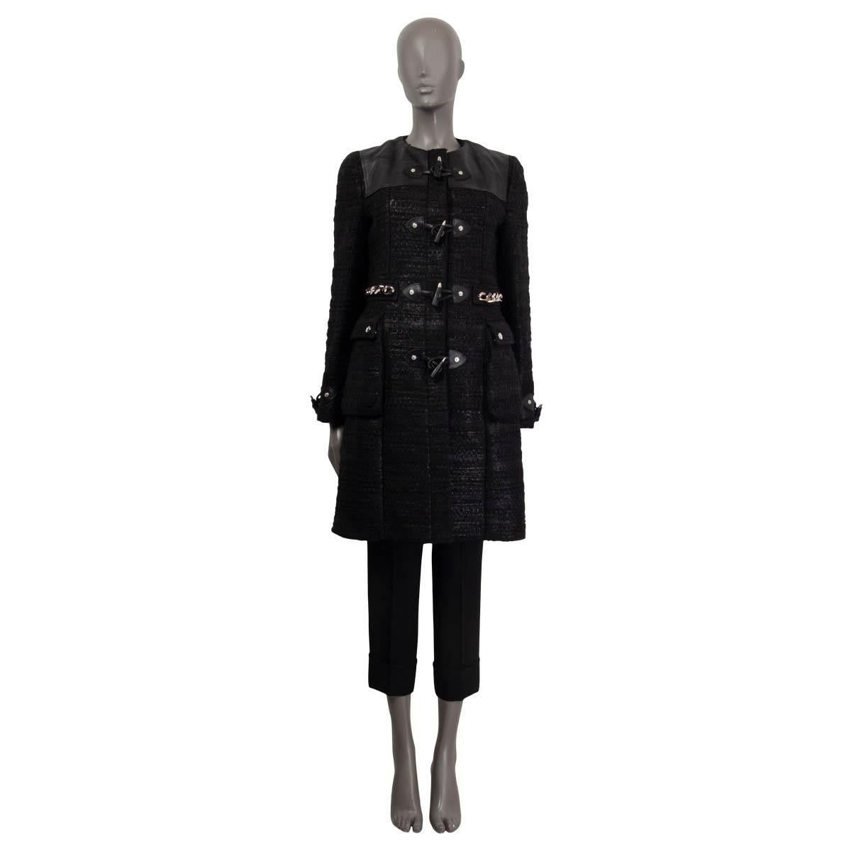 100% authentischer Dufflecoat von Givenchy aus schwarzem Acryl (87%) und Wolle (13%). Mit Ledereinsätzen an den Schultern, Knebelmanschetten und zwei aufgesetzten Taschen mit Knöpfen vorne. Mit einer silbernen Kette um die Taille verziert. Wird mit