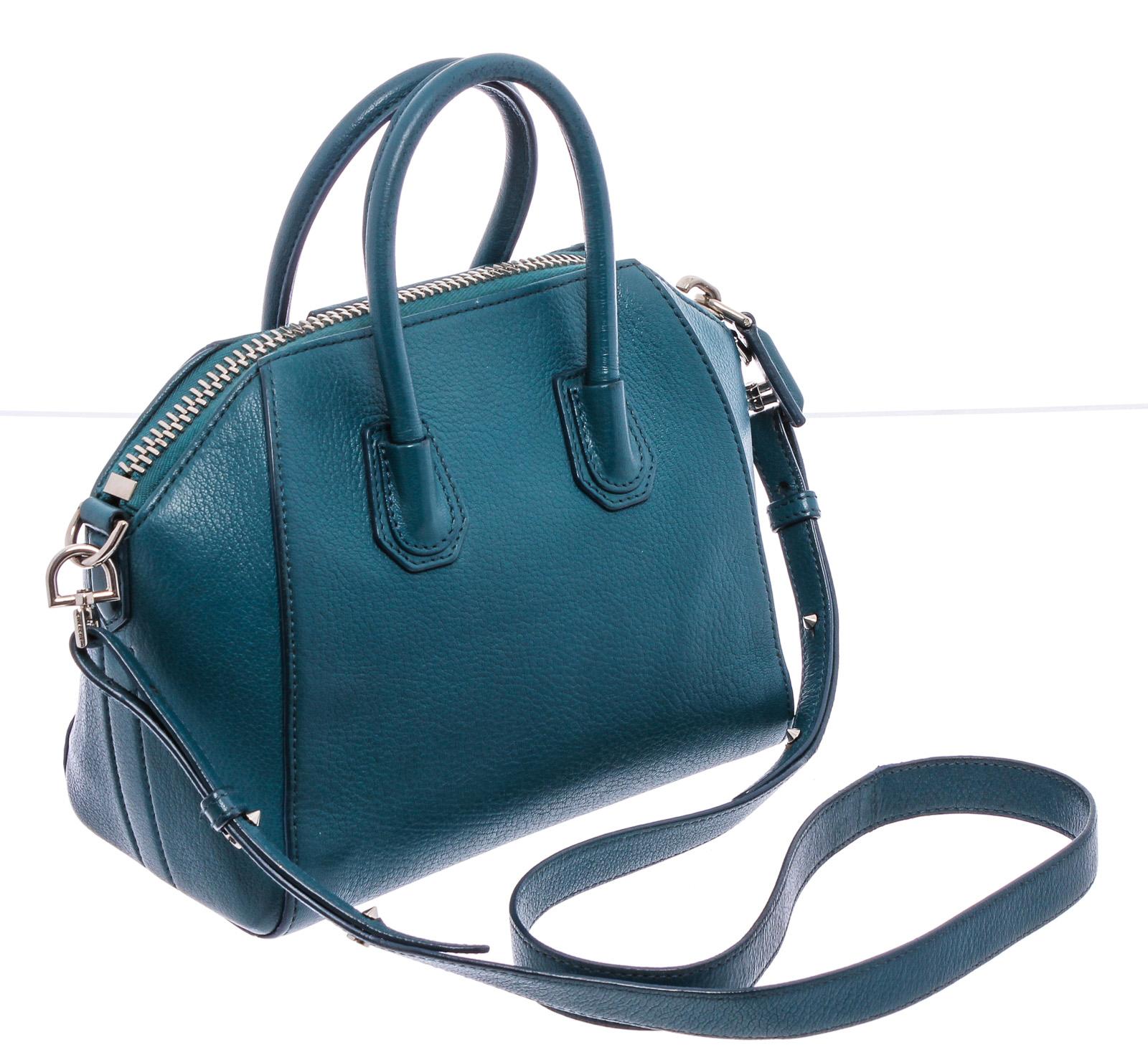 Givenchy blue grained leather Mini Antigona bag with silver-tone hardware, beige canvas lining, two interior slip pockets, interior zip pocket, optional leather crossbody shoulder strap, and zip top closure.

20359MSC 
