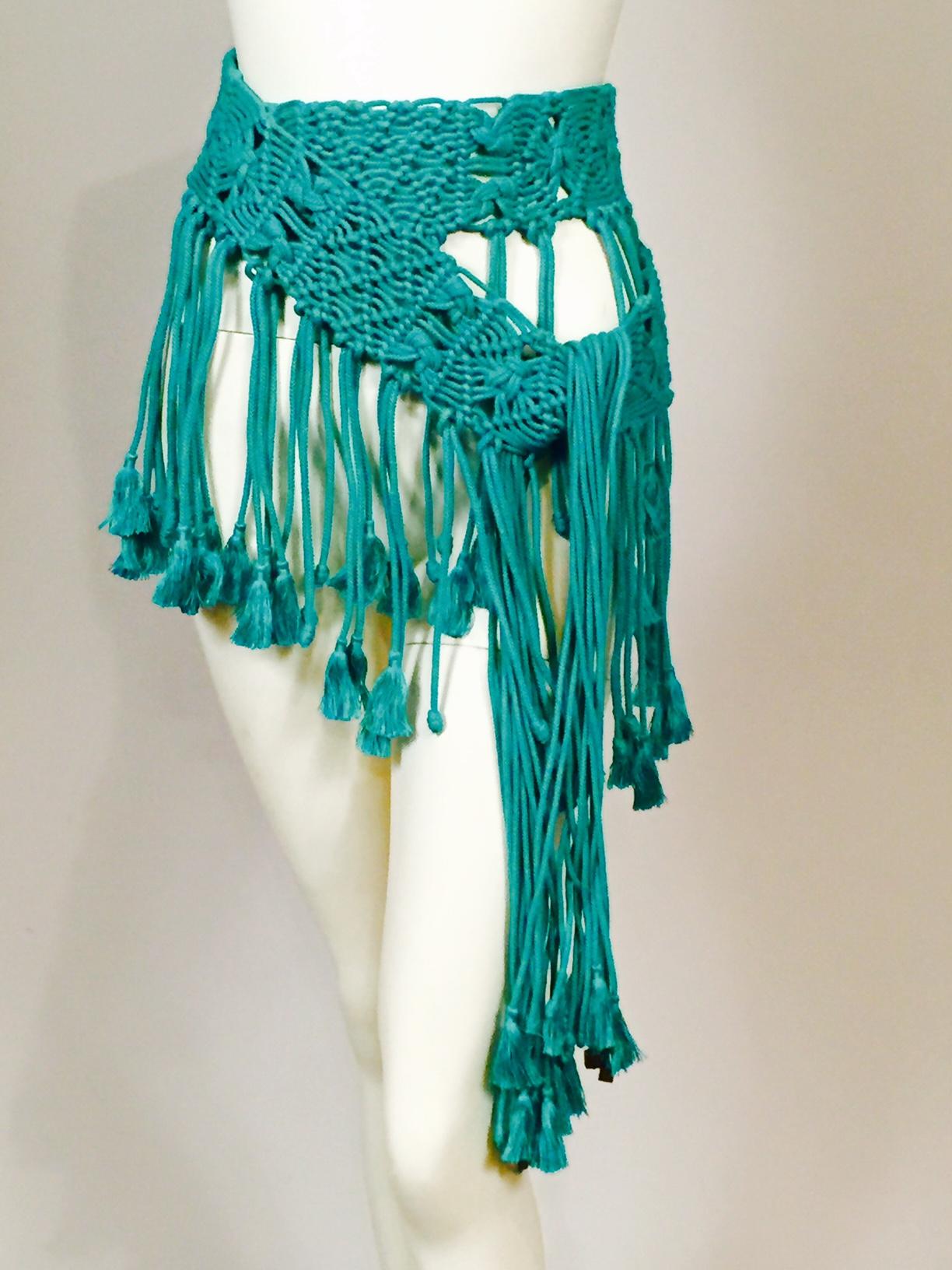 This amazing belt will transform any outfit, the color, design and movement are just fabulous. A wide band of  macrame is finished with a long fringe consisting of pairs of cord with either tassels or knots at the ends. Both ends of the belt are