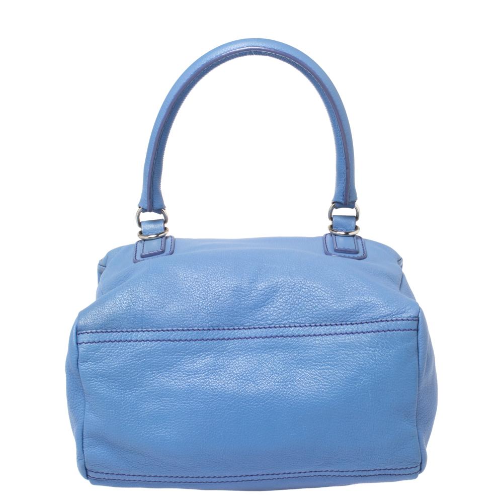 This bag from Givenchy in blue is stylish and functional. Crafted from leather, the Pandora bag features double zipper fastenings and a single handle. The insides are canvas-lined and the bag is complete with the brand logo on the front, silver-tone