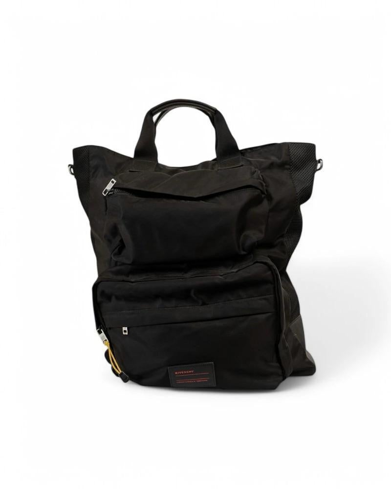 Givenchy signature duffel bag, model UT3 in large size, made of black nylon with leather trim and silver hardware. Equipped with a top magnetic button closure, internally lined with tone-on-tone nylon with convenient pocket, very roomy. Equipped