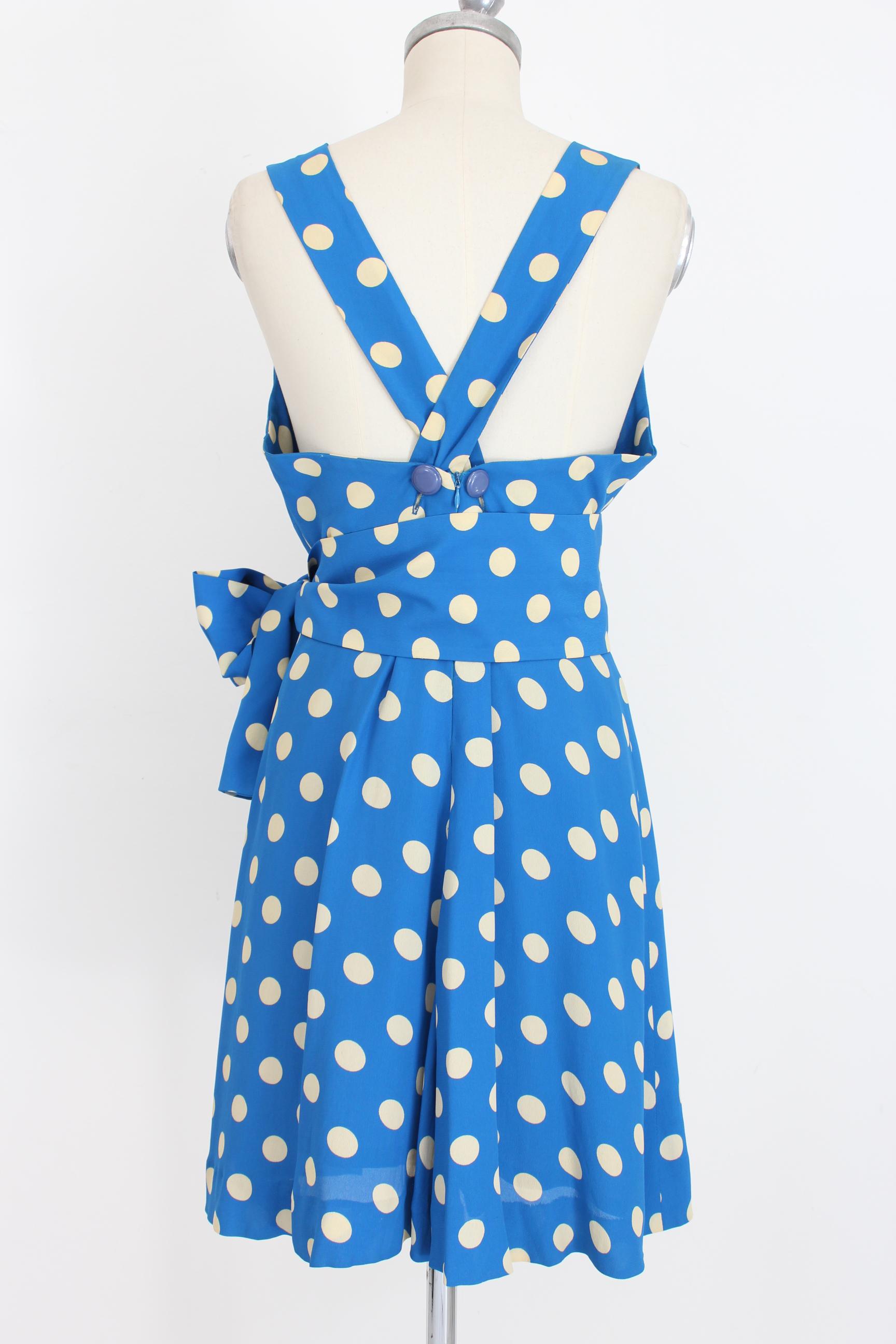 Givenchy Boutique 80s vintage women's dress. Rockabilly style dress, deep neckline with crossed bands on the back. Blue color with white polka dots. Adjustable waist belt. 100% silk. Made in France. Very good vintage conditions, some small spots