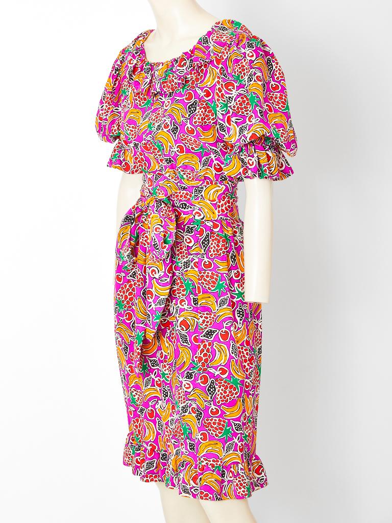 Givenchy Boutique, silk, multi tone, tropical print, day dress, having a flounced collar, a full, 3/4 sleeve with a ruffle and a ruffled hem. Self belt ties at the waist. 