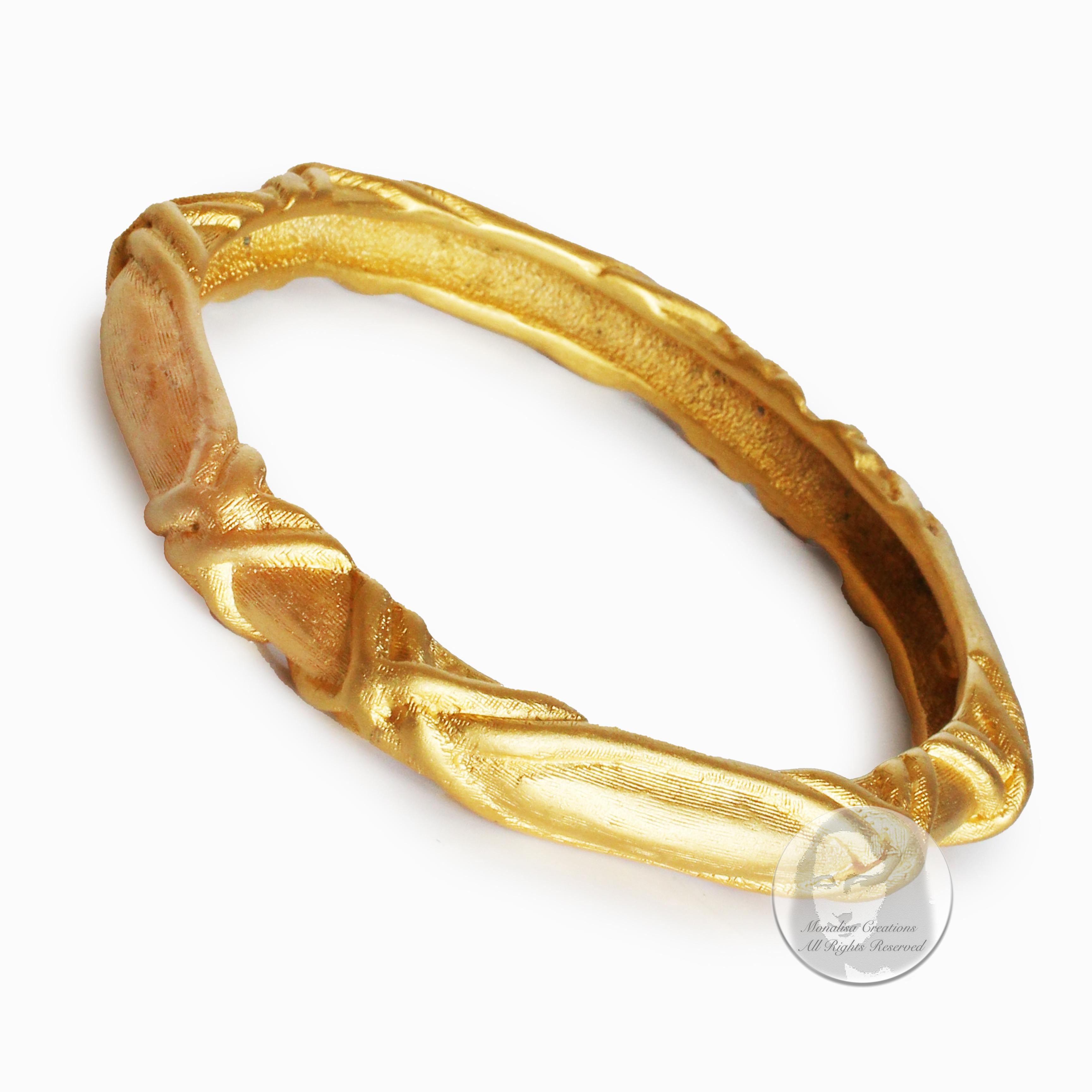 Preowned, vintage Givenchy bangle bracelet, most likely made in the 80s.  Made from gold metal, this bangle features an abstract cross pattern throughout.  

Looks amazing as it is - or pair it with your other favorite bangles! The abstract texture