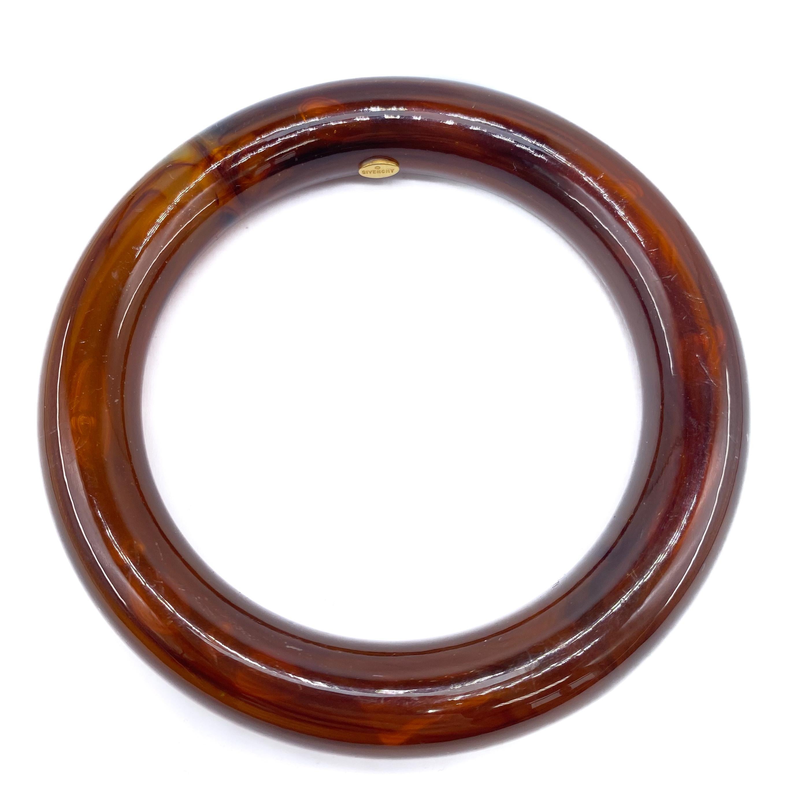 Givenchy Vintage 1980s Bracelet

Timelessly elegant and versatile lucite bangle from the iconic House of Givenchy

Detail
-Crafted from a rich mahogany lucite
-Made in the 1980s

Size & Fit
-Inner circumference 8 inches 
-Slides on and