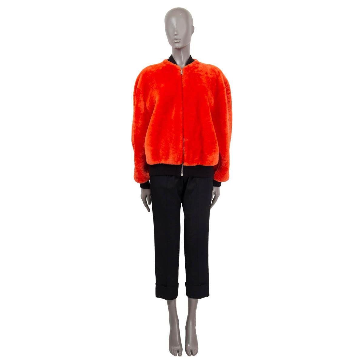 100% authentic Givenchy shearling bomber jacket in bright orange lambskin (100%). Features elastic cuffs, an elastic waistband and two slit pockets on the front. Opens with a zipper on the front. Semi-lined in viscose (57%) and polyester (43%).