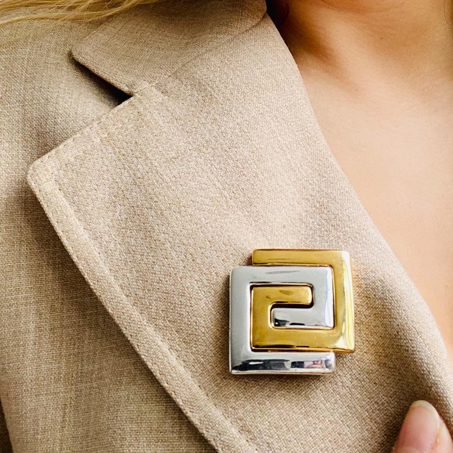 Givenchy 1980s Vintage Brooch.

Detail
-Made in France in the 1980s
-Features the Givenchy double G logo in a gold and silver coloured base metal 

Size & Fit
-Approx 3.3 cm x 3.3 cm / 1.3 inches x 1.3 inches

Authenticity & Condition
- Fully