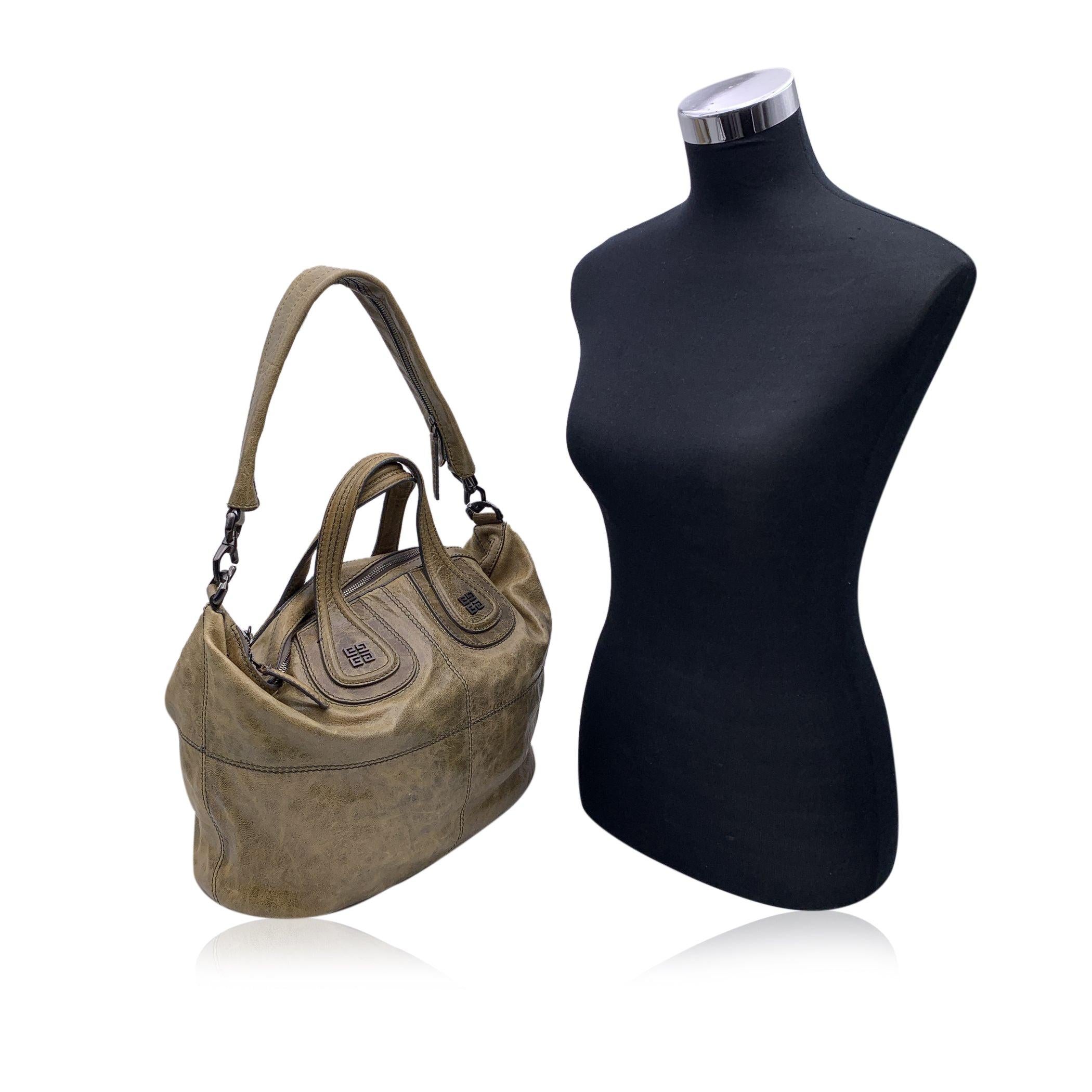 Givenchy 'Nightngale' bag in light brown leather trim and handles. Upper zipper closure opens to a roomy interior with a beige fabric lining. 1 side zip pocket and 2 side open pockets. 2 bag handles on top and removable shoulder strap. 'GIVENCHY -