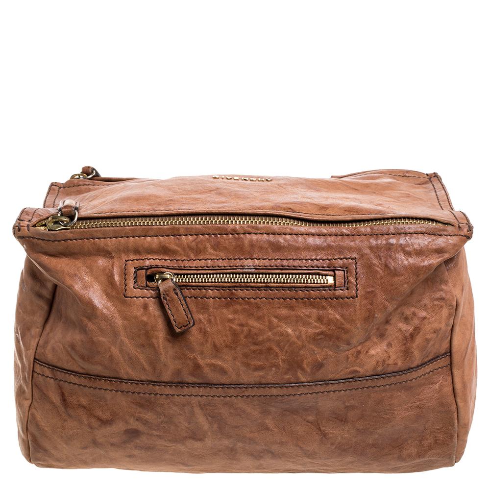 This bag from Givenchy in brown is stylish and functional. Crafted from quality leather, the Pandora bag features double zipper fastenings and a single handle. The insides are fabric-lined and the bag is complete with the brand logo on the front,