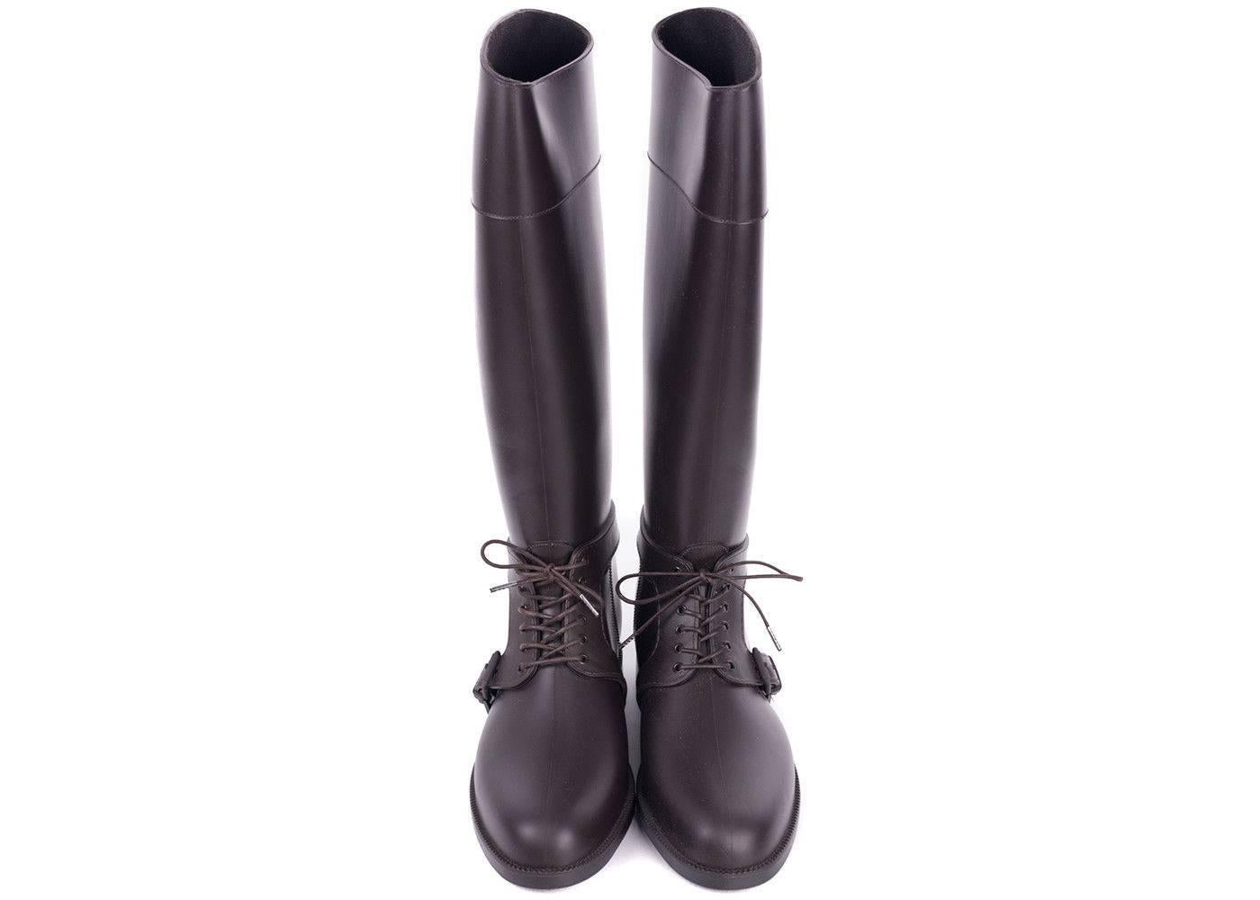 Step into the rain with Equestrian confidence in your Givenchy Rain Boots. These durable rubber boots feature tonal laces,  wrap around harness belt, and knee-high length. These shoes can be paired with denim or and all black outfit for your