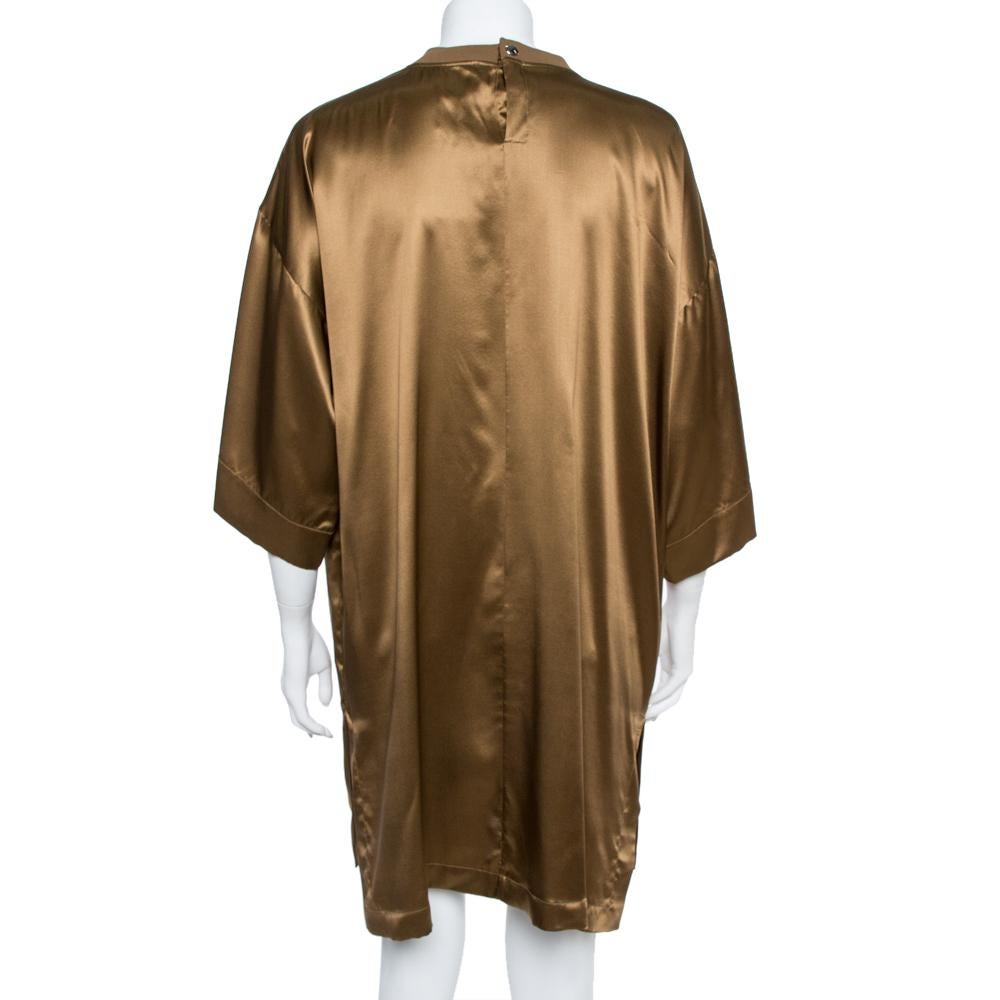 This pretty tunic from the house of Givenchy is a wardrobe staple; it is tailored luxuriously in a comfortable silhouette featuring a brown shade, a satin finish all over and relaxed, three-fourth sleeves. Wear this tunic for a statement-making