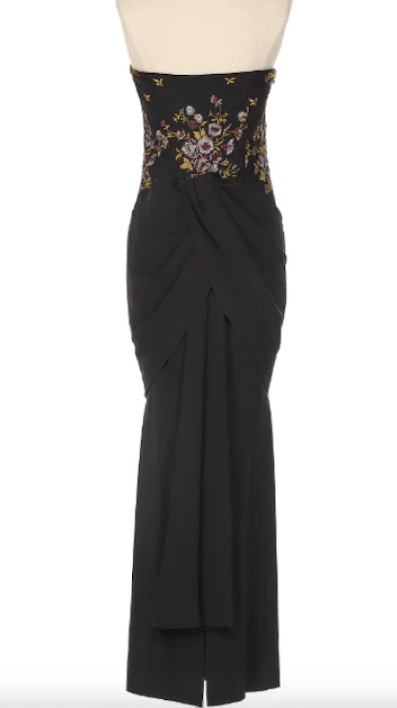 Givenchy by Alexander McQueen Black Evening Gown with Purple Flowers. This is a stunning dress that shapes the body beautifully. The floral detail added as a testament to Alexander McQueen's artistry and innovation, while remaining true to