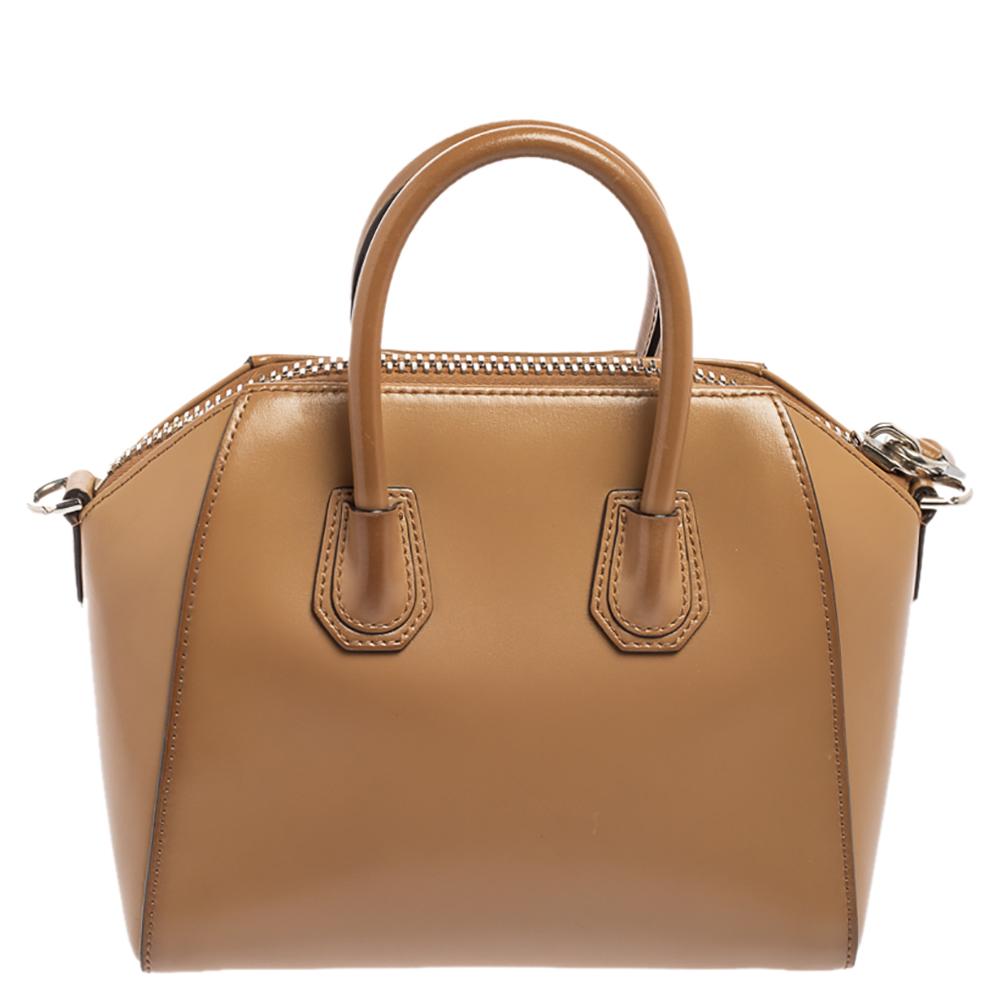 Made in Italy, and loved by women worldwide is this beautiful Antigona satchel by Givenchy. It has been crafted from leather and shaped elegantly. The brown bag has a top zipper that reveals a canvas interior and it is held by two top handles and a