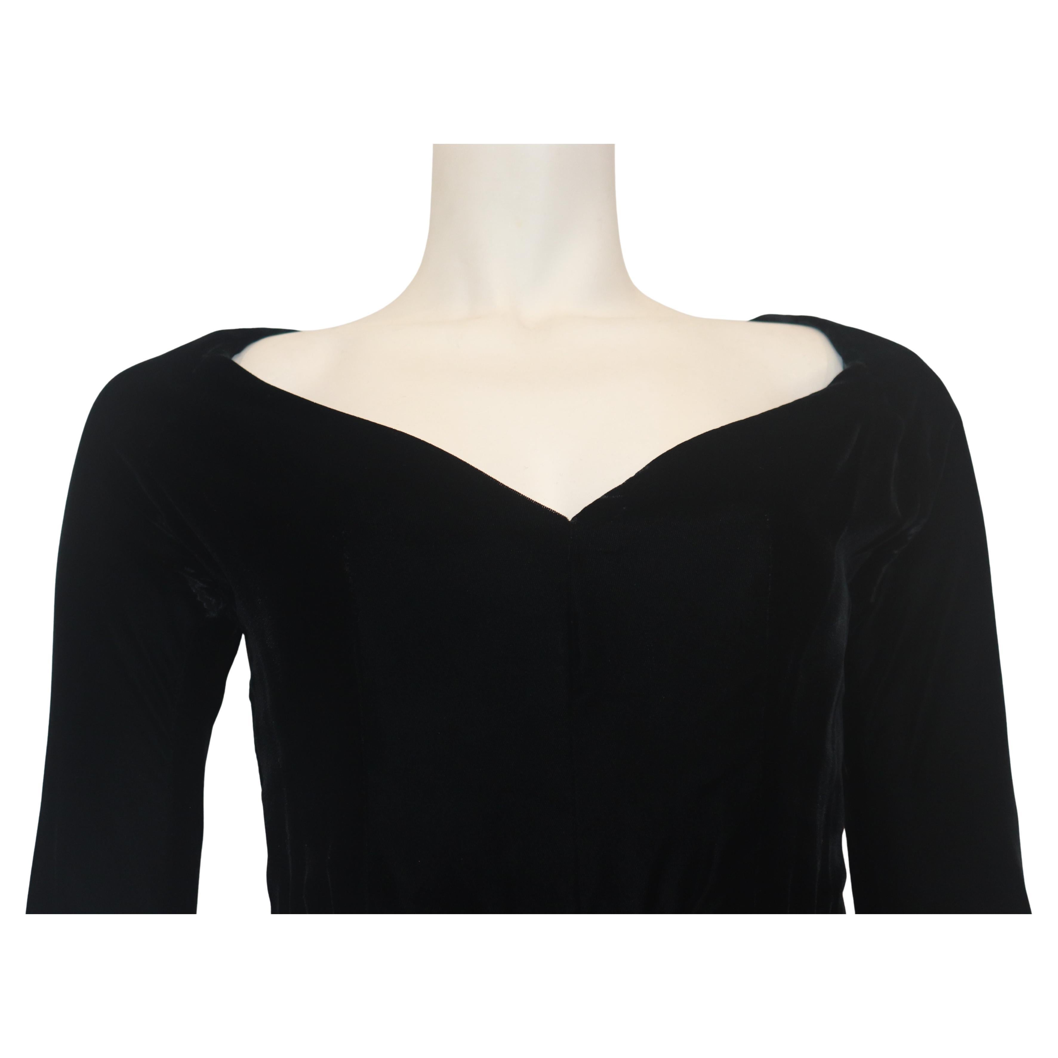 GIVENCHY COUTURE black velvet gown with mesh inserts and rhinestone striped skirt detail. 
This gown is black velvet with long sleeves and a wide v-neck neckline. 
Towards the bottom of the skirt are three wide mesh stripes outlined with tiny,