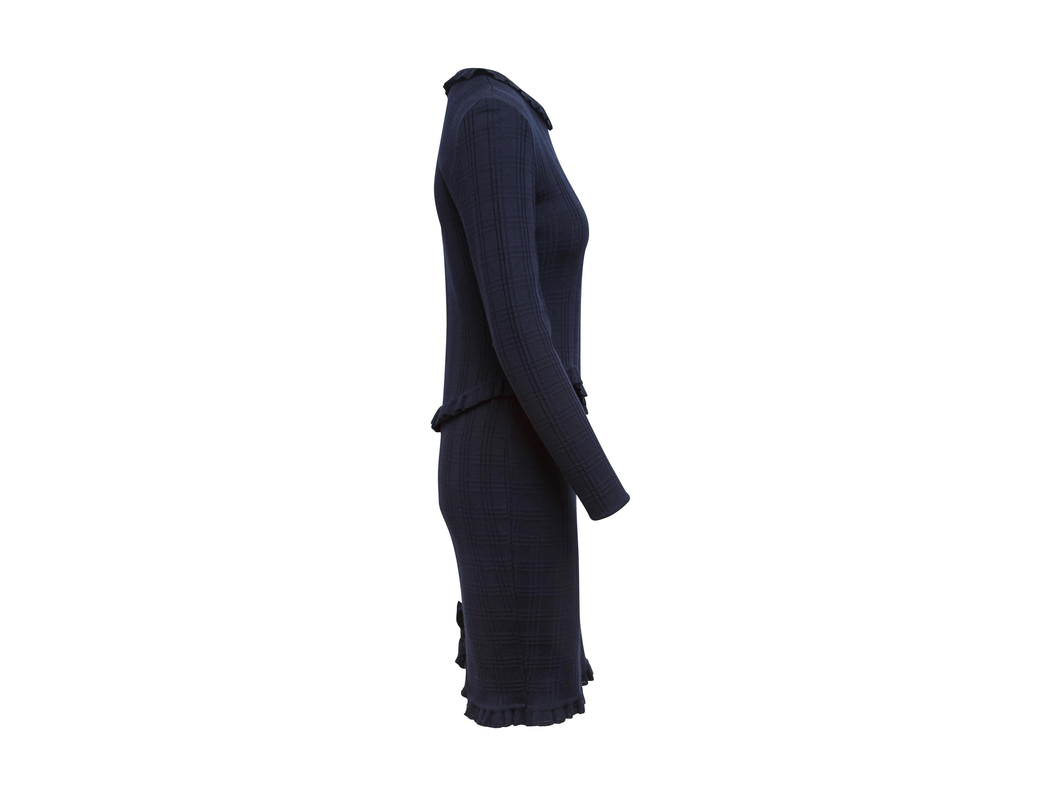 Product details:  Vintage navy blue knit midi dress by Givenchy Couture.  Accented with ruffles.  Roundneck.  Long sleeves.  Concealed back zip closure.  Bow accents back center hem.  35