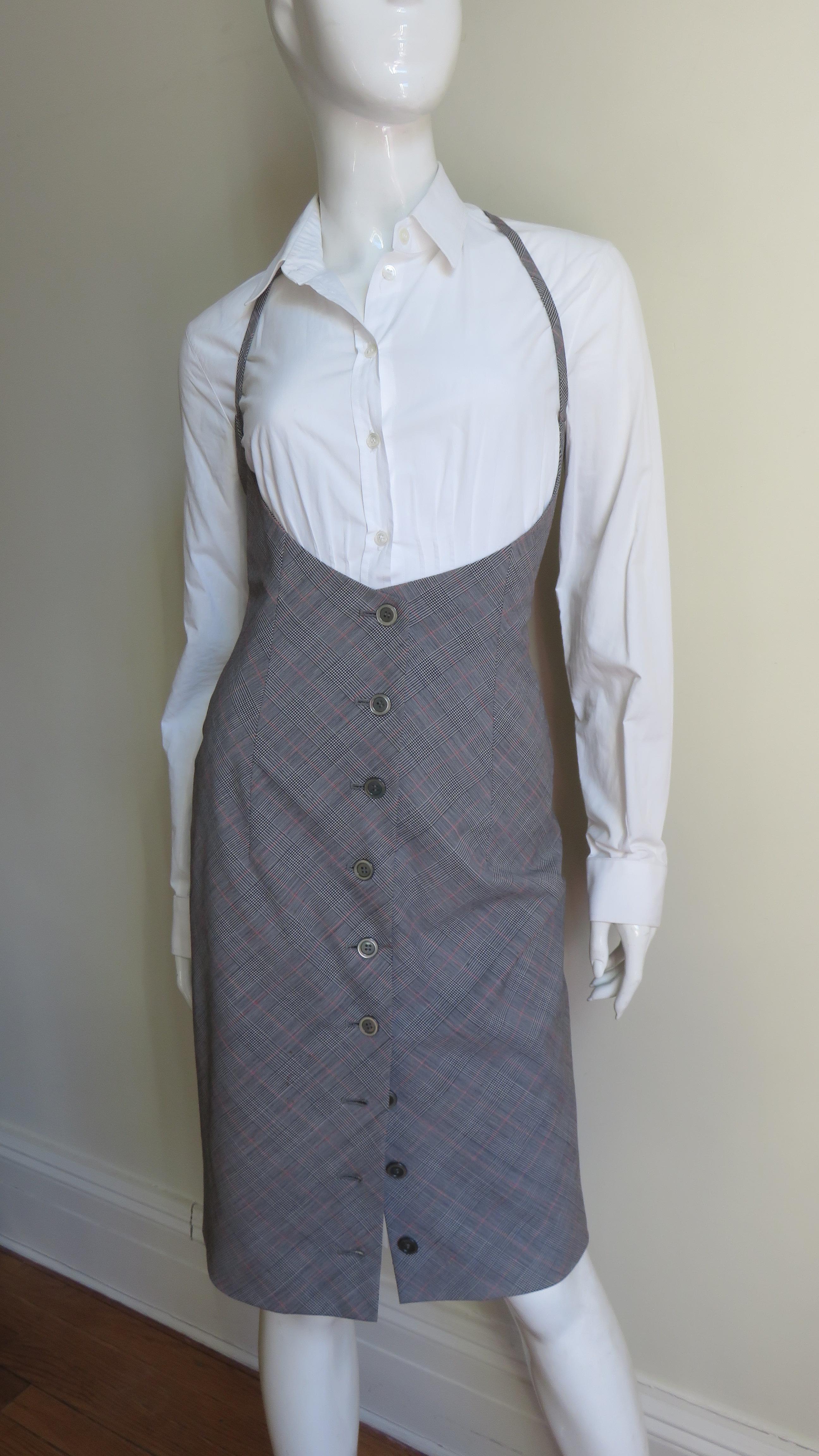 A fabulous light weight fine wool black and white plaid jumper dress.   It has a halter strap extending from the below the bust to around the neck, center front functional buttons and it is fully lines in grey silk. Photos including a shirt are for