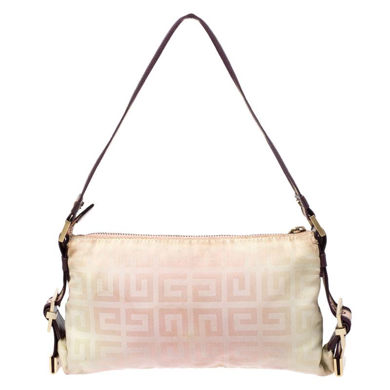 Flaunt your style with this lovely baguette from Givenchy. Crafted from the brand's signature logo print canvas, it comes in a stunning shade of beige. It features two exterior pockets, a single handle, a top zip closure that opens to reveal a