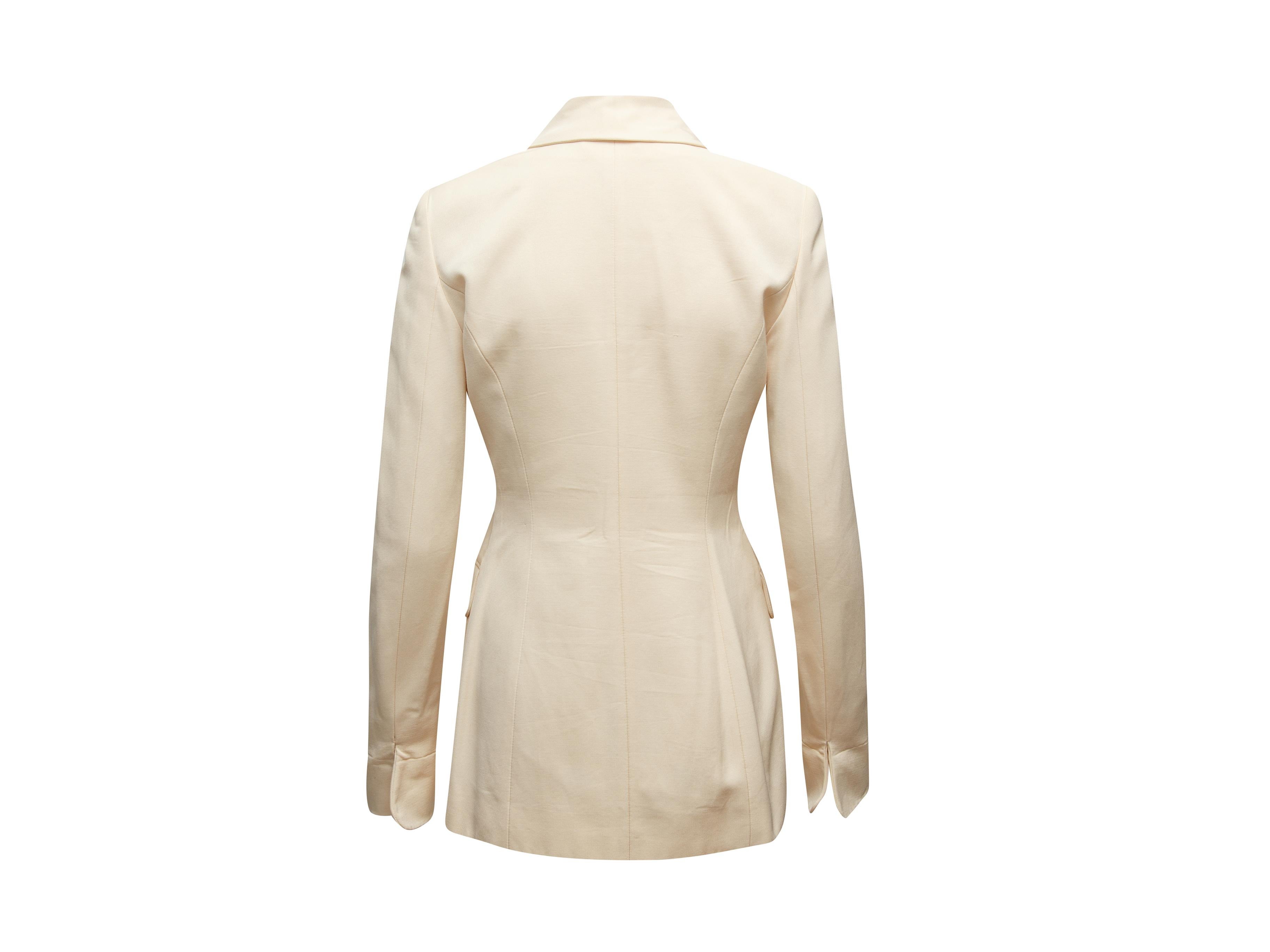 Product details: Vintage cream skirt suit by Givenchy. Pointed collar. Dual flap pockets. Button closures at front. Designer size 38. Blazer- 30