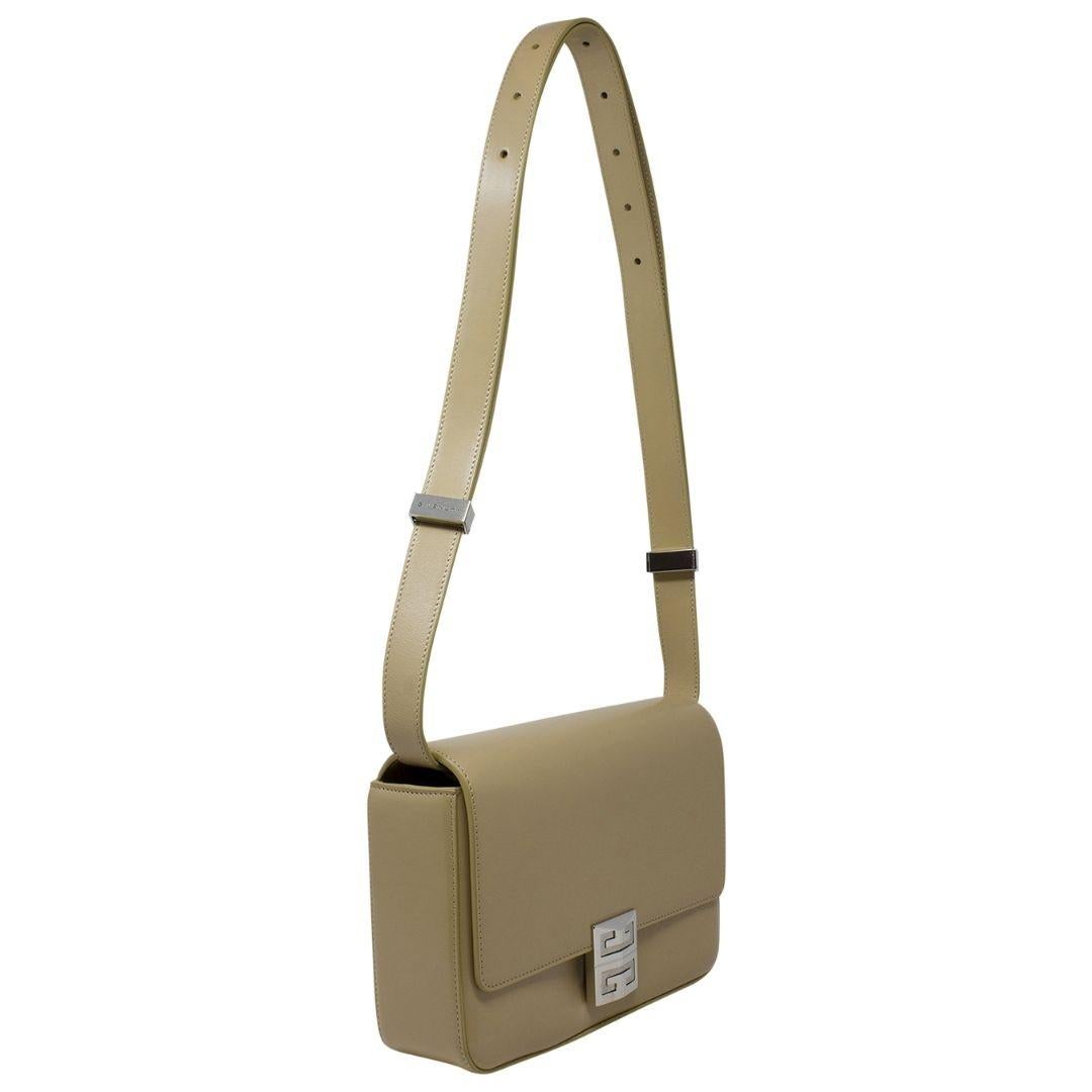 In a soothing creme shade, this calfskin leather bag is a stylish and practical accessory. The silver hardware complements the color, and the snap closure ensures safety for your belongings. Two interior slip pockets provide additional storage and