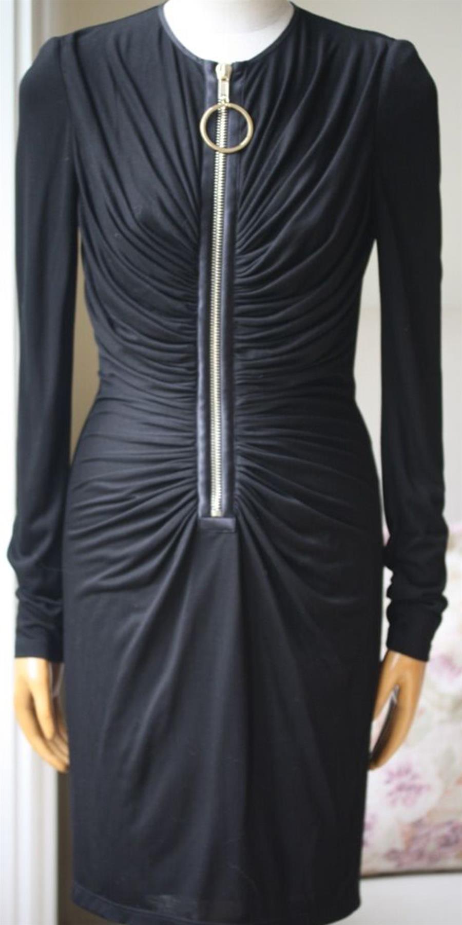 This black jersey dress by Givenchy is comfortable and lightweight, featuring elegant drape detailing around the bust and waist that flawlessly flatters the figure. Black jersey. Concealed zip fastening at back. 85% Viscose, 15% silk; fabric2: 100%