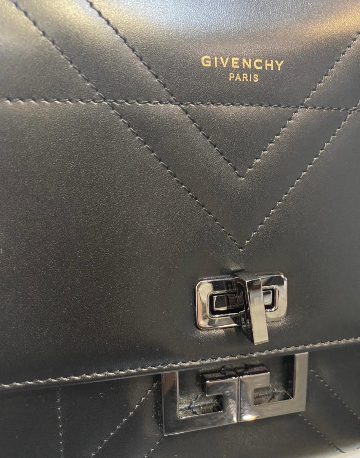 Givenchy Eden bag. 
in black leather and silver hardware.
measurements:
height 20 cm
length 24 cm
width 9 cm
the shoulder strap can be extended up to 53 cm. Excellent overall condition but has a scratch on the back as shown in the photo. and some