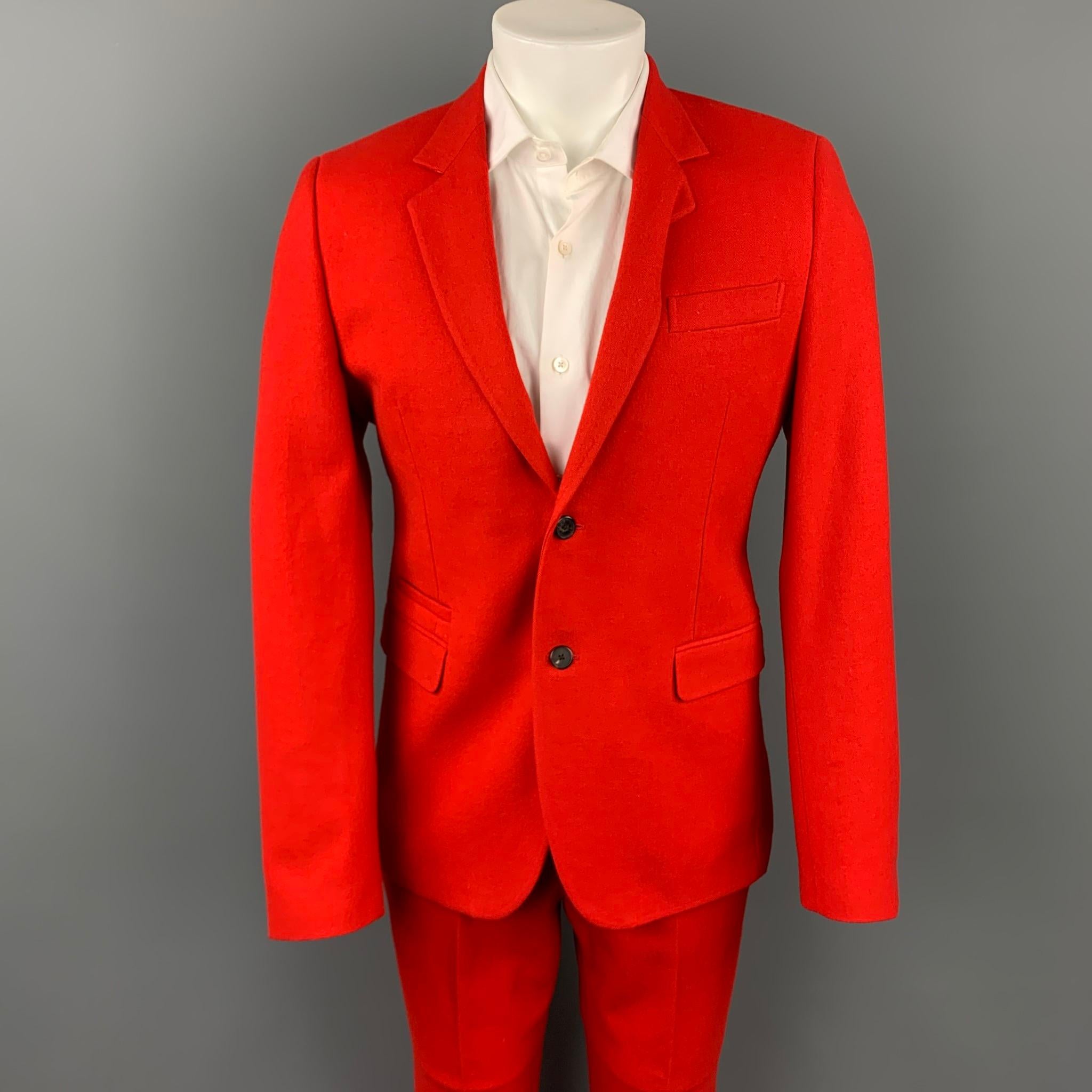 GIVENCHY suit comes in a red wool / cotton with a full liner and includes a single breasted, two button sport coat with a notch lapel and matching flat front trousers. Made in Italy.

Very Good Pre-Owned Condition.
Marked: IT