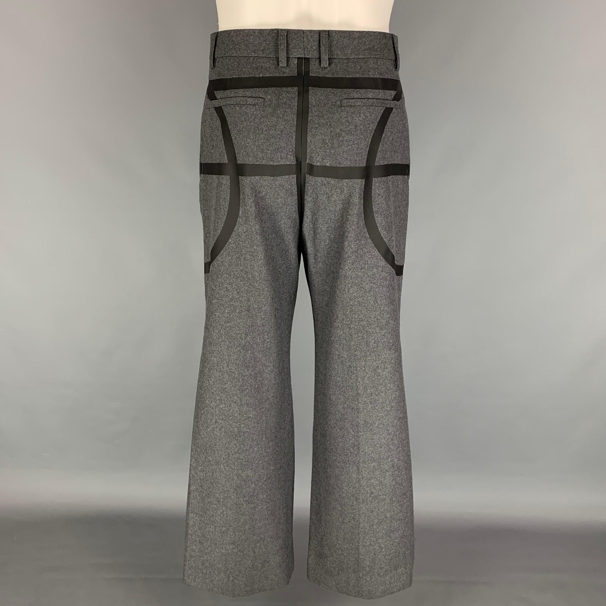 GIVENCHY Fall 2014 'Basketball Collection' dress pants comes in a gray wool with a black trim design featuring a wide leg style, pleated, high waist, front tab, and a zip fly closure. Made in France.

Excellent Pre-Owned Condition.
Marked: