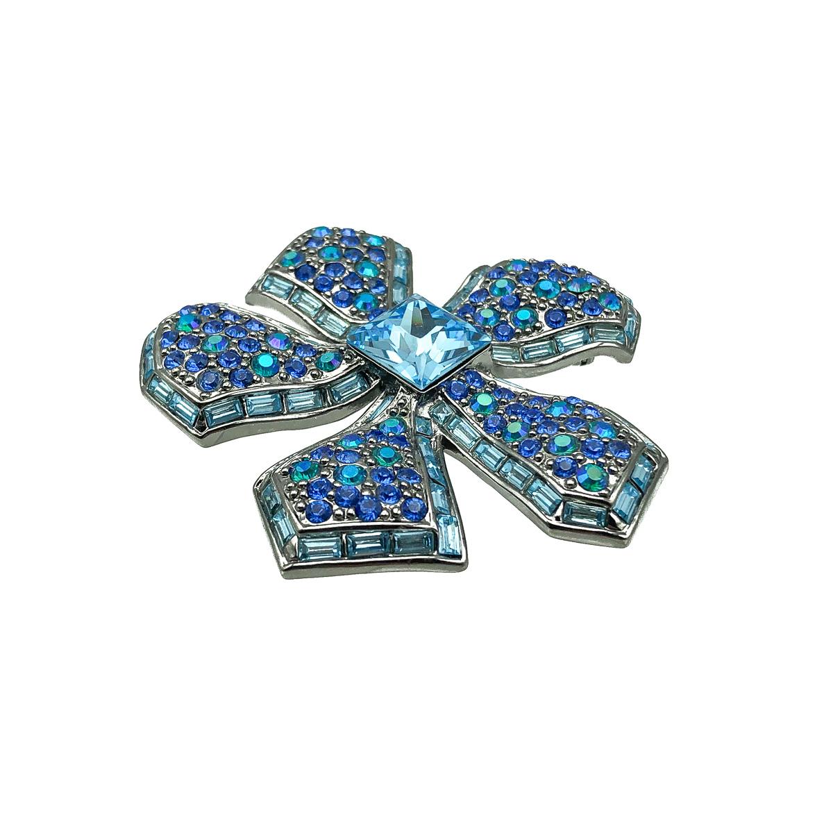 A ultra pretty Givenchy Flower Brooch. Crafted in blackened silver tone metal and set with a stunning array of fancy cut blue crystals. Very good condition, signed, approx. 6cms. A dazzlingly pretty brooch from the House of Givenchy. 

Established