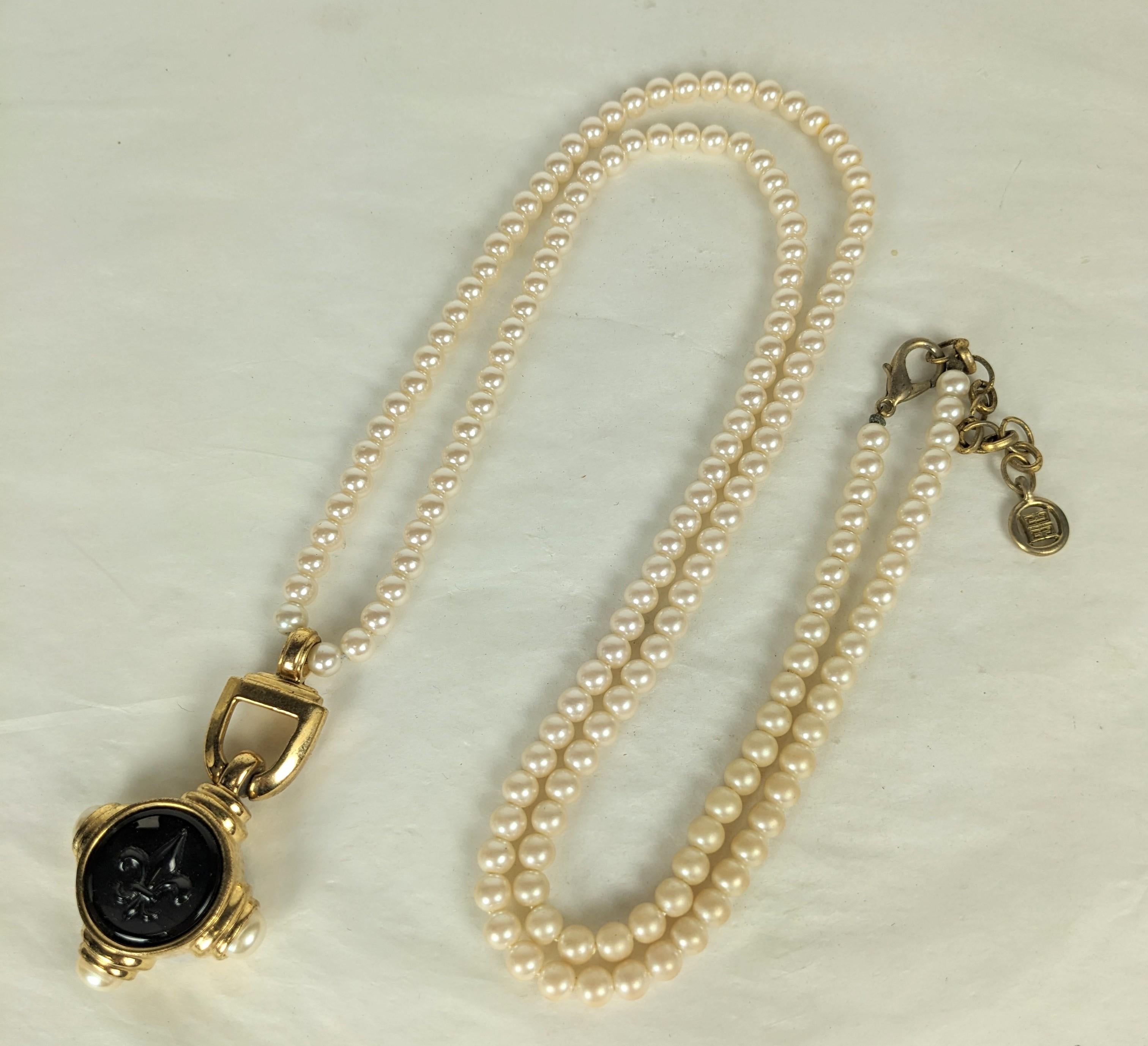 Givenchy Fleur de Lis Pearl Pendant Necklace from the 1990's. Long faux pearls of gilt pendant with glass fleur de lis cameo and faux pearls. Signed on pendant and clasp. 1990's France. 
Pendant 2.5