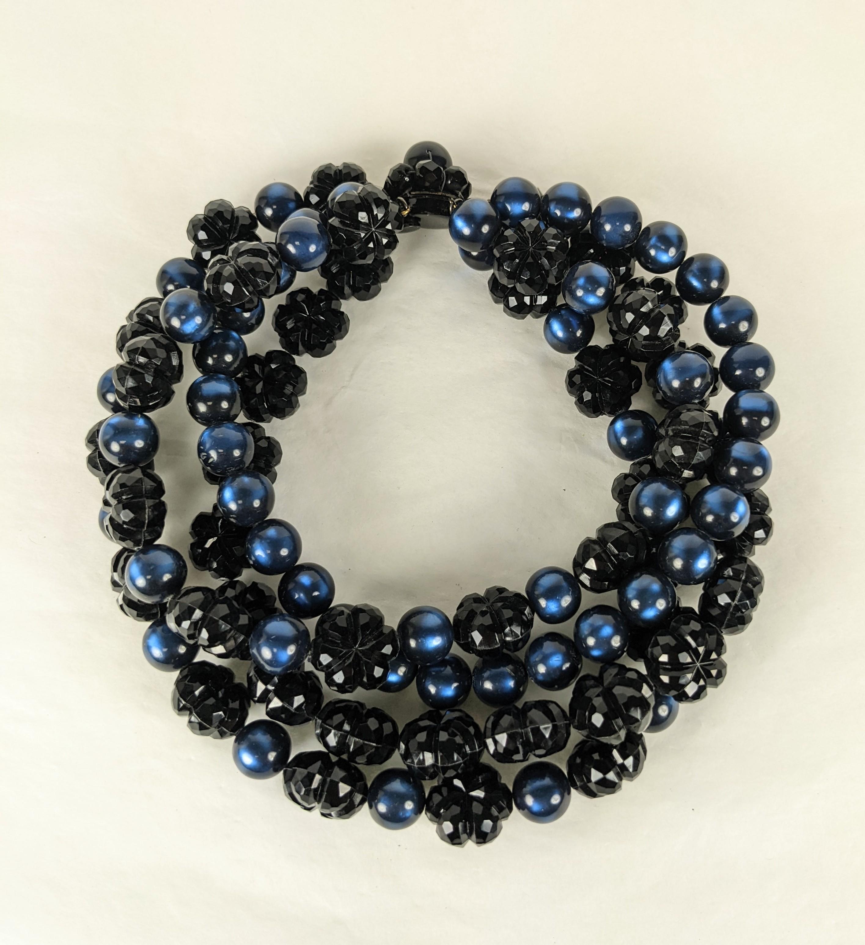 Hubert de Givenchy Haute Couture choker from the estate of Bunny Mellon. Composed of  4 strands of large faceted jet bead hand sewn flower heads and moonglow cats eye deep sapphire resin beads. Japanned black enameled  metal clasp. Made in