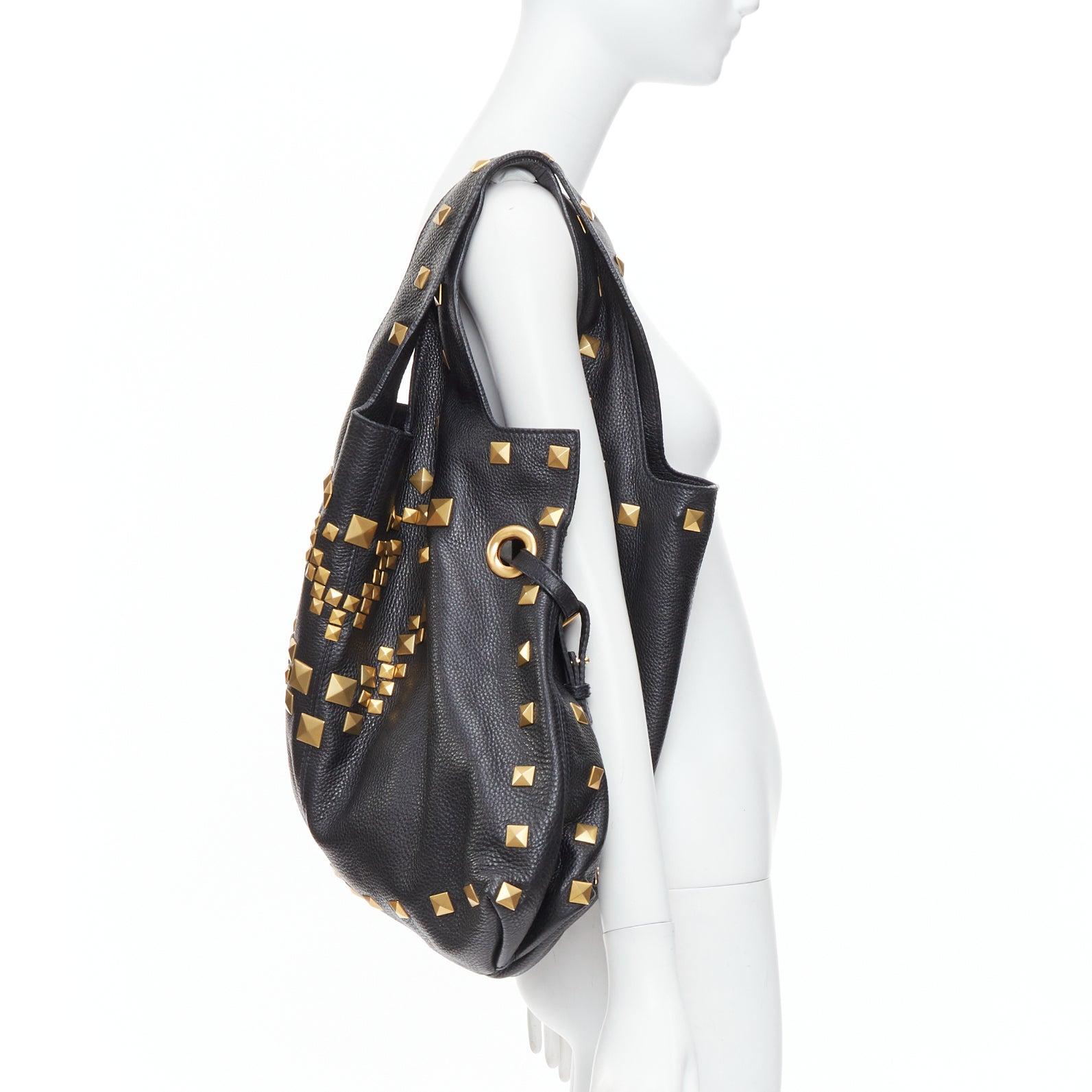 GIVENCHY George V black textured leather gold giant studs tote bag
Reference: NKLL/A00490
Brand: Givenchy
Designer: Riccardo Tisci
Model: George V
Material: Leather
Color: Black, Gold
Pattern: Solid
Lining: Black Fabric
Extra Details: Black shopper